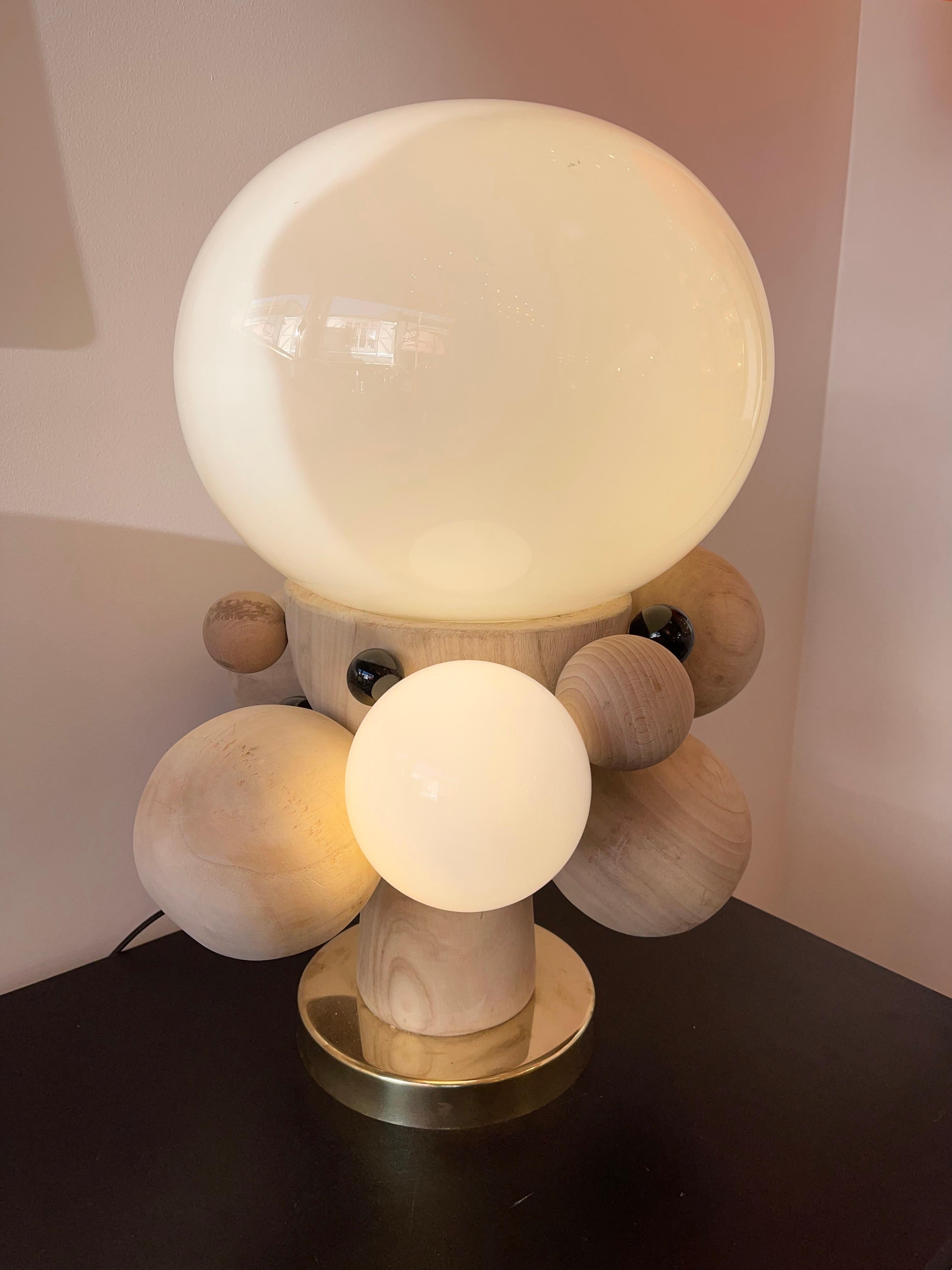 Pair of table or bedside brass lamps, Opaline Murano glass, black ball of Murano glass and massive natural wood. Contemporary work from a small italian artisanal design workshop in a Mid-Century Modern Space Age Brutalist style.