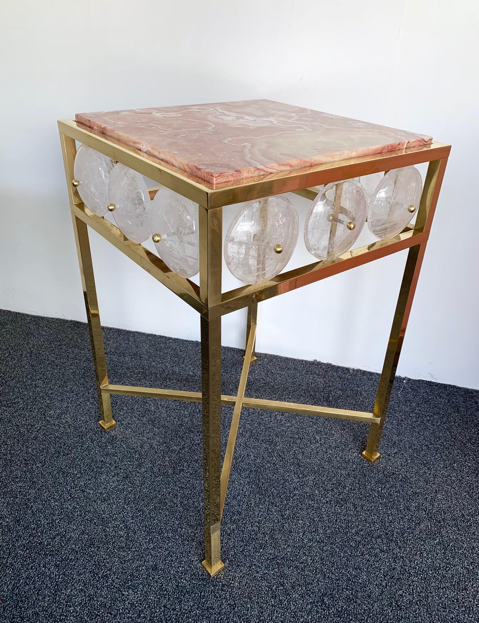 Contemporary pair of brass side end tables or night stands with large rock crystal pieces and rare red onyx top, different from marble. Neoclassical inspired style Louis XVI. Small Italian workshop, few exclusive and quality production. Also