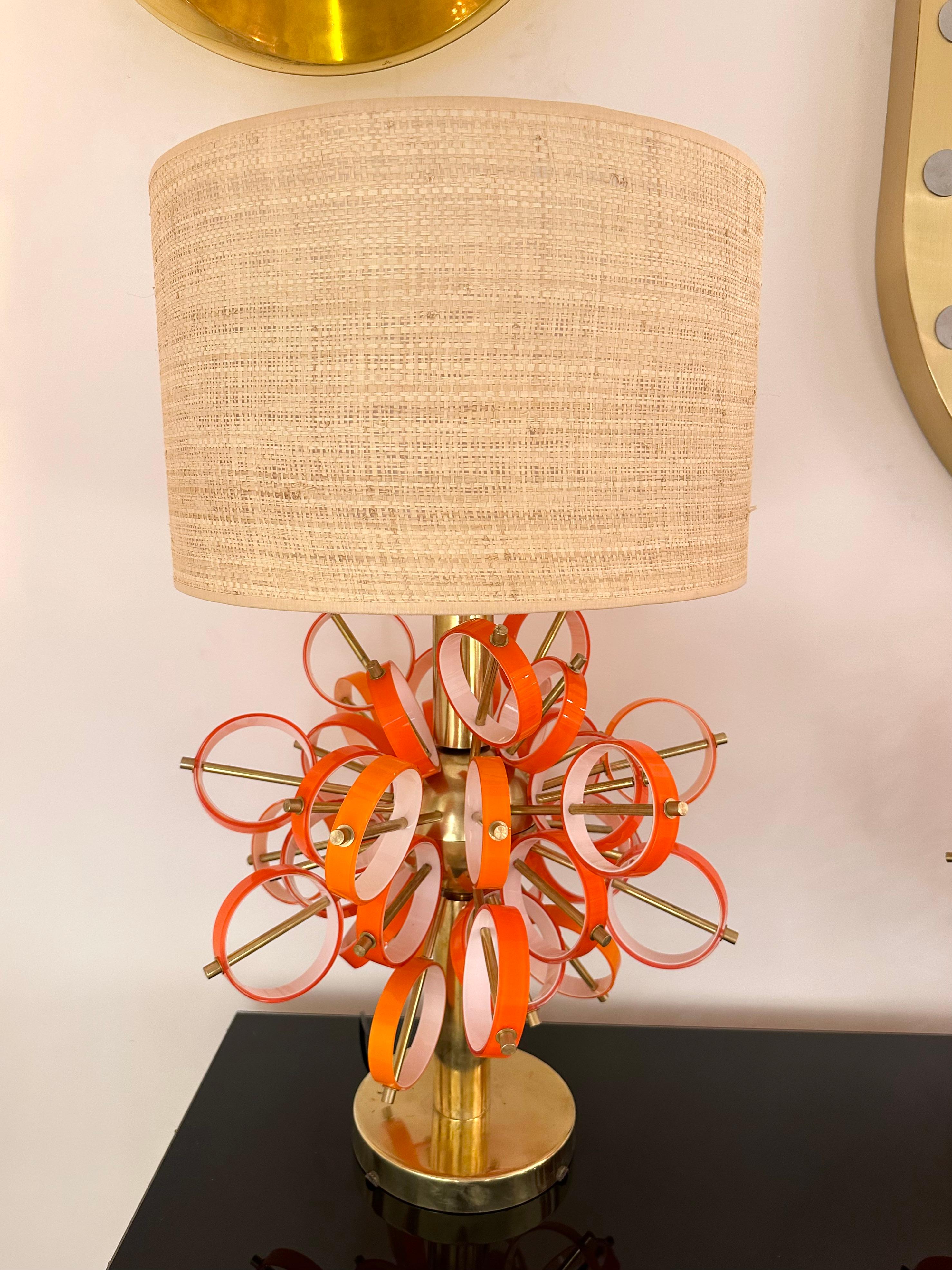 Pair of table or bedside brass sputnik lamps with orange and white Murano glass rings. Contemporary work from a small italian artisanal workshop. Minor imperfections possible due to artisanal handmade work, in a Mid-Century Modern Space Age