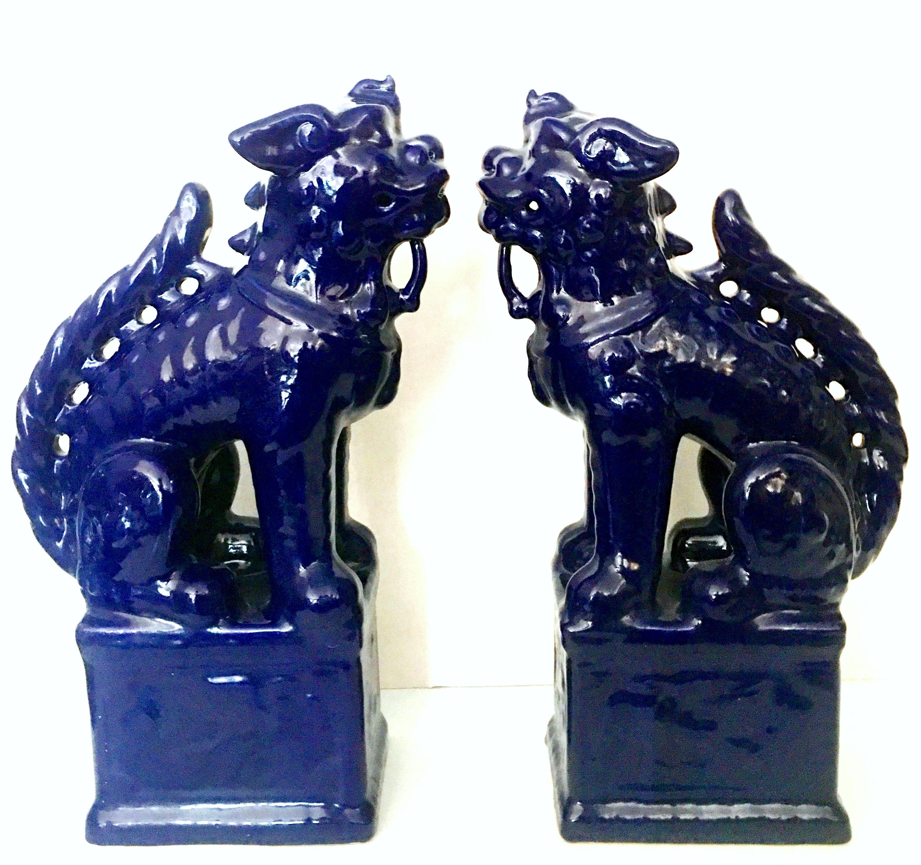 21st Century Pair Of Chinese foo lion sculptures. These tall vibrant cobalt foo dog sculptures are made of glazed ceramic and are a high gloss finish.
New-Floor Sample.