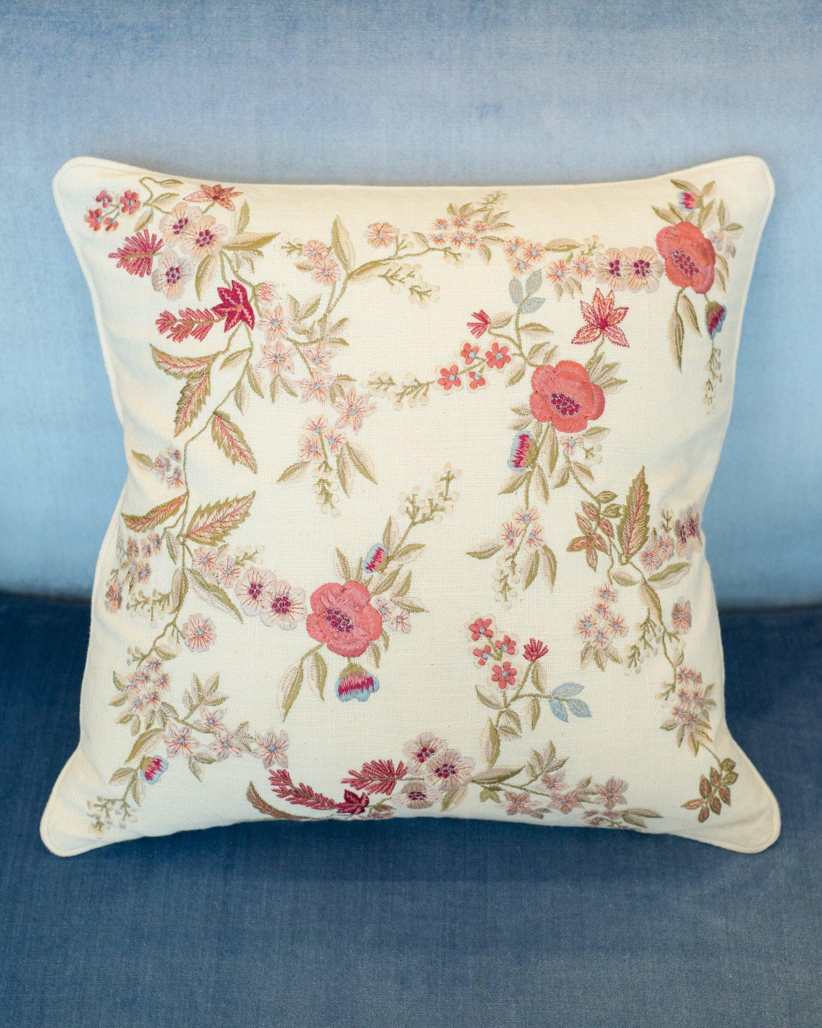 A pair of cotton cushions from Anke Dreschel featuring ornate floral embroidery, square shape and concealed rear zip fastening. Filled with 100% Canadian feather and down.