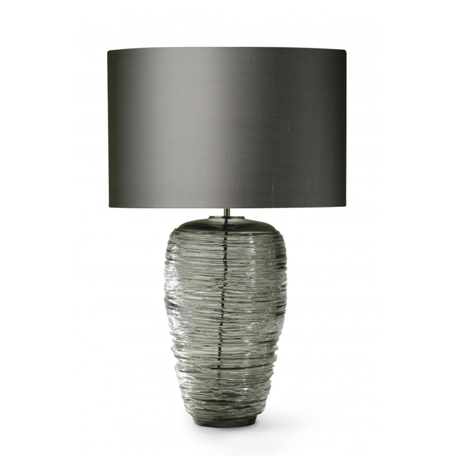 The beauty of this table lamps is the blown grey glass: they are  handmade by Italian Masters with horizontal signs following the Midcentury design.
The result is a piece of elegance and charmed. The grey color is fine and glamour.
These stunning 