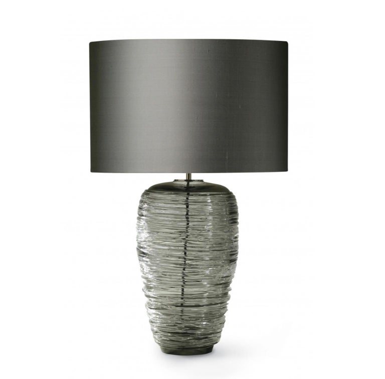 The beauty of this table lamp is the blown grey glass: it is handmade by masters with original horizontal signs following the midcentury design.
The result is a piece of elegance and charmed. The grey color is contemporary and glamour.

EU
