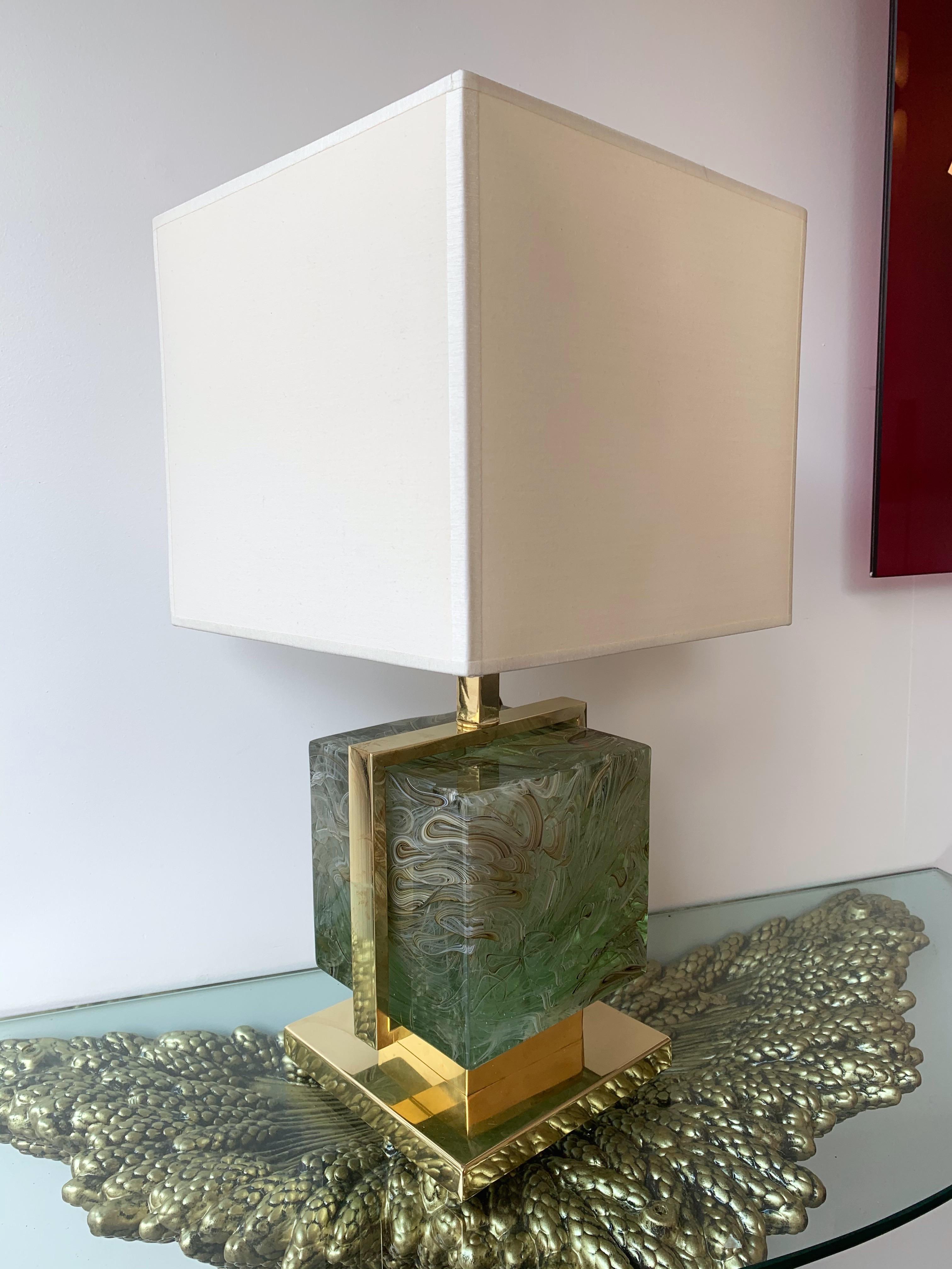 Very fresh pair of brass cage lamps with an impressive and massive color green jade Murano pressed glass cube. Measures: Height top of lamp 42 centimeters. Demonstration shades not included. In the style of Mazzega, Poliarte, Venini, Vistosi, La