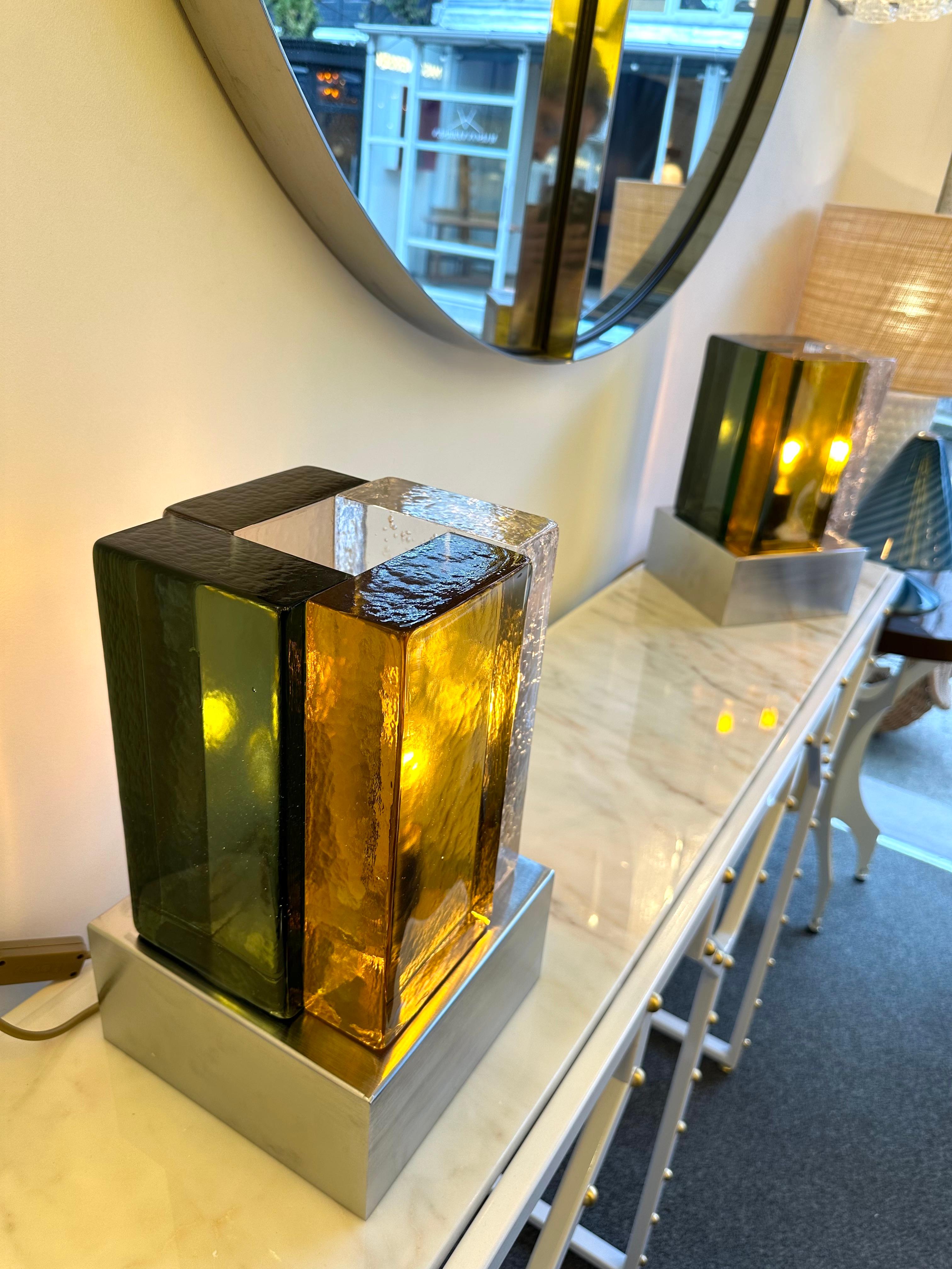 Pair of contemporary table or bedside lamps cubic pressed green amber and bubble clear Murano glass block and stainless steel base. Few exclusive artisanal italian design production workshop. In the Mid-Century Modern Space Age style of Mazzega,