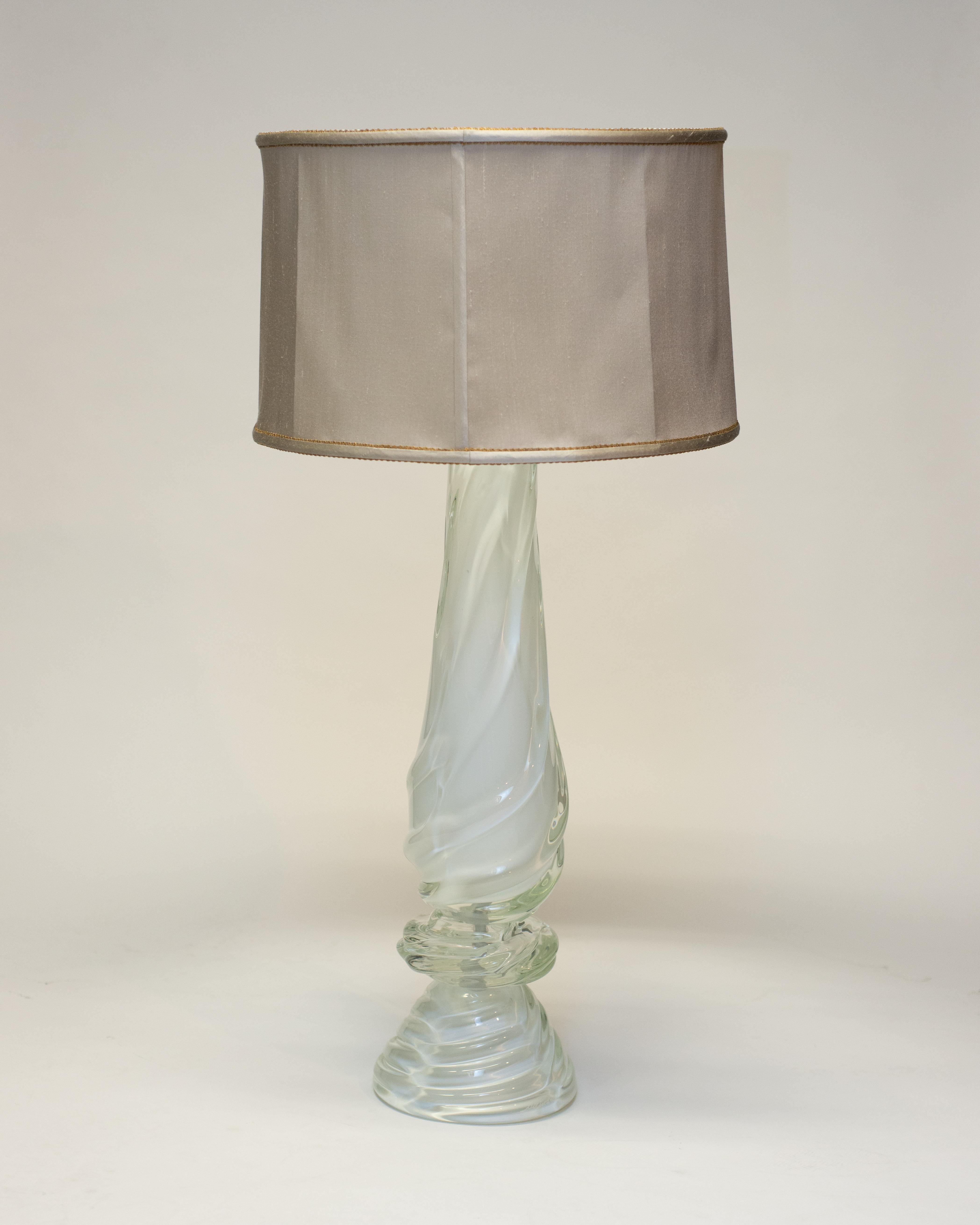 A pair of large white Murano milk glass lamps suitable for many style of interior. These grand and elegant lamps are fitted with custom drum silk shades, finished with vintage metallic trims. Wired for North American Outlets.