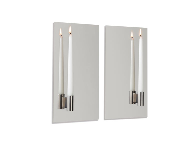 Strikingly simple and minimal, the contemporary asymmetrical Candle wall sconce, made from mirror polish stainless steel, reflects the light doubling it’s effect. This listing for a set of two Sconces which are perfect on either side of a fireplace
