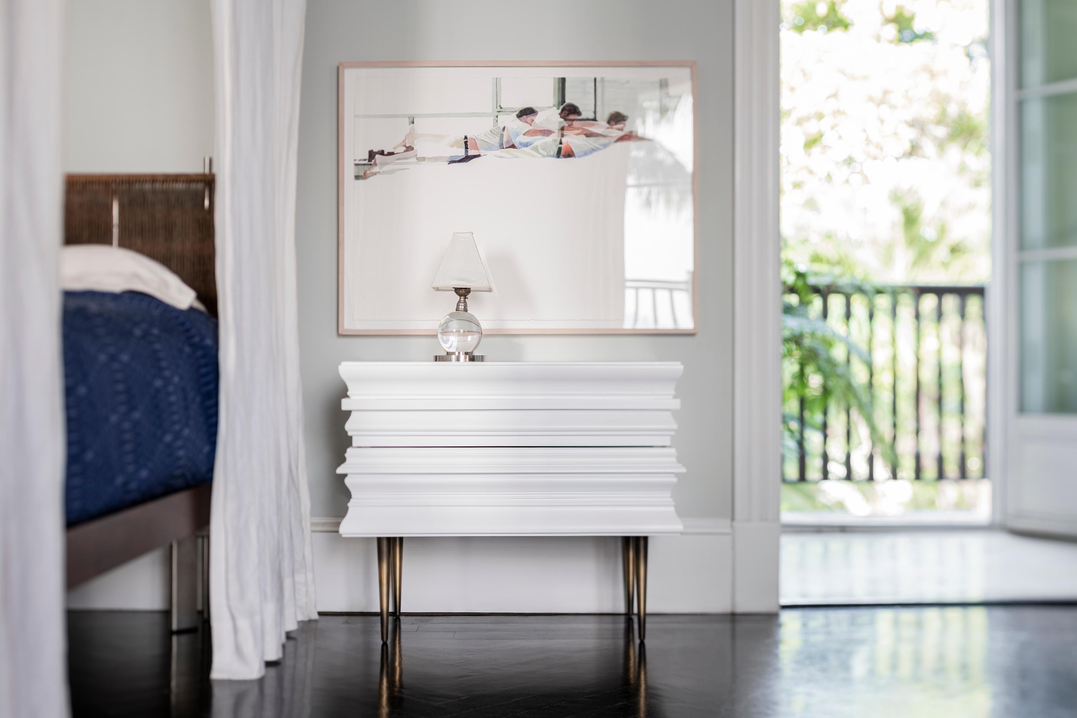 Finest crafted darkened wood moldings with a sleek highlight of silver lacquered nightstands. Moldings are applied to conceal drawers and acting as handles for the nightstands. The process to achieve the nightstand ’s surface is the result of the