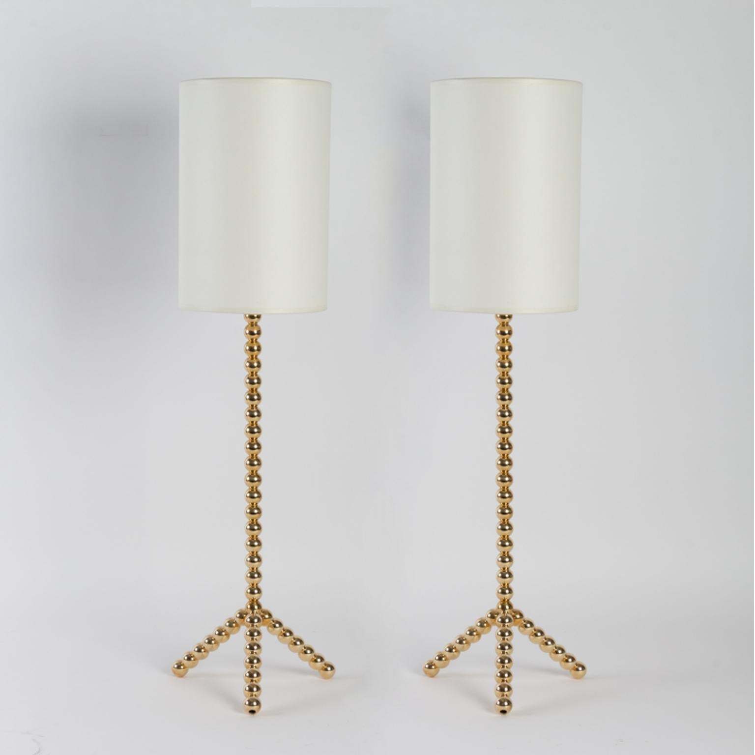 Fancy pair of table lamps, made of solid brass pearls, tripod base and off-white cotton lampshades.
Contemporary creation edited by Vingtieme: our gallery. These lamps are handmade in Paris, in the Marais district by skilled craftsmen of the