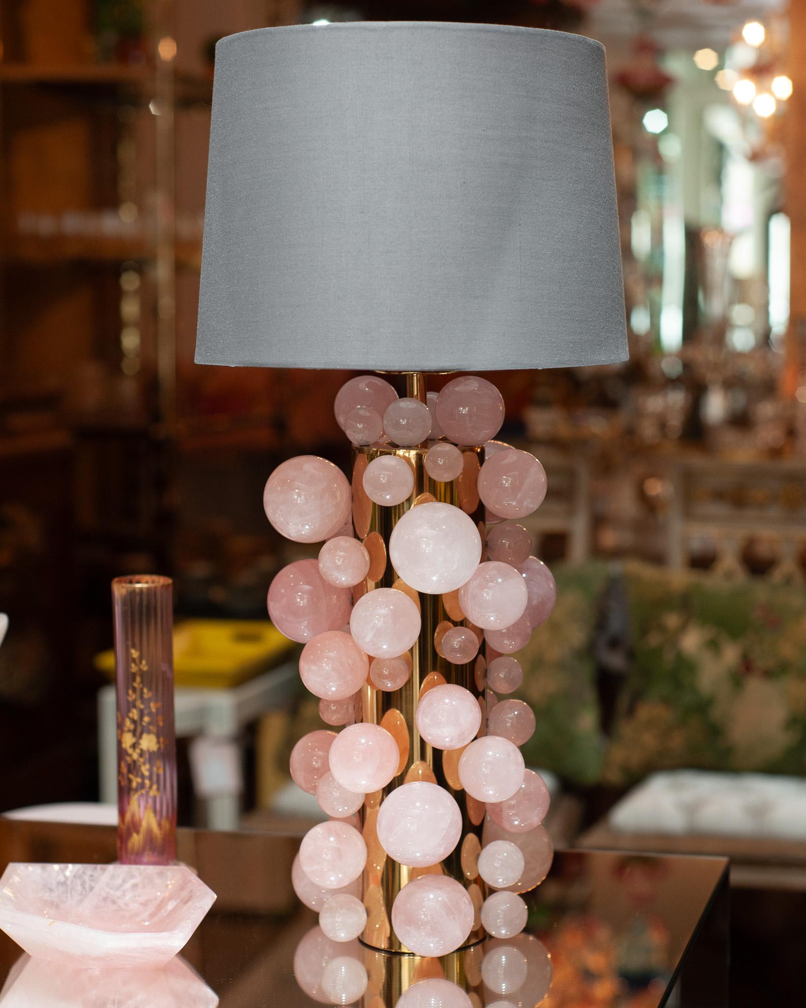 This stunning pair of rose quartz sphere lamps with polished brass bases exudes elegance and sophistication, making a bold statement in any interior. Each lamp features a cylindrical base in gleaming polished brass, which contrasts beautifully with