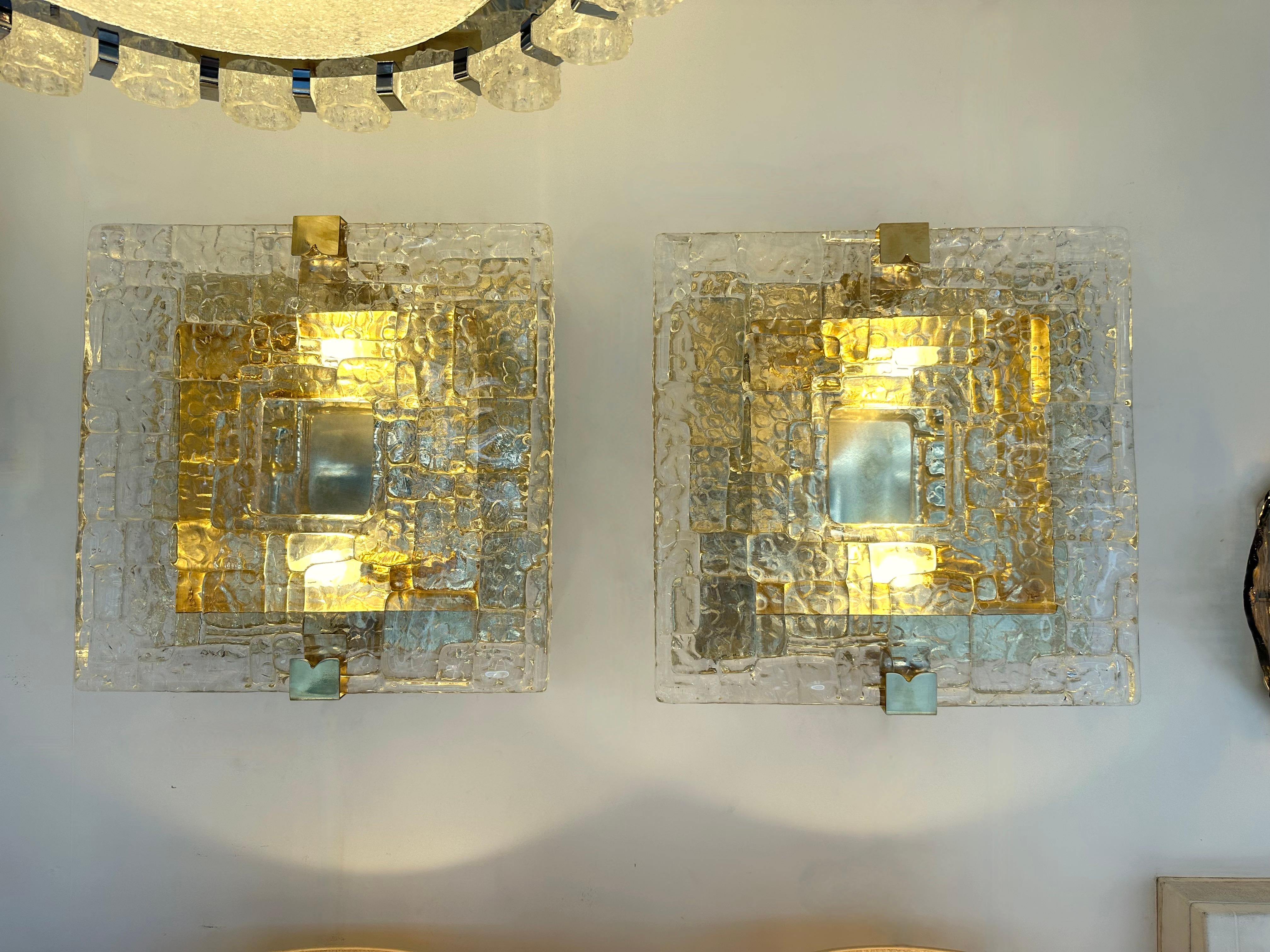 Pair of wall lights lamps sconces with Murano glass textured blade and brass. Contemporary work from a small italian artisanal workshop. Minor imperfections due to artisanal handmade work. In the mood of Mid-Century Modern Space Age Hollywood