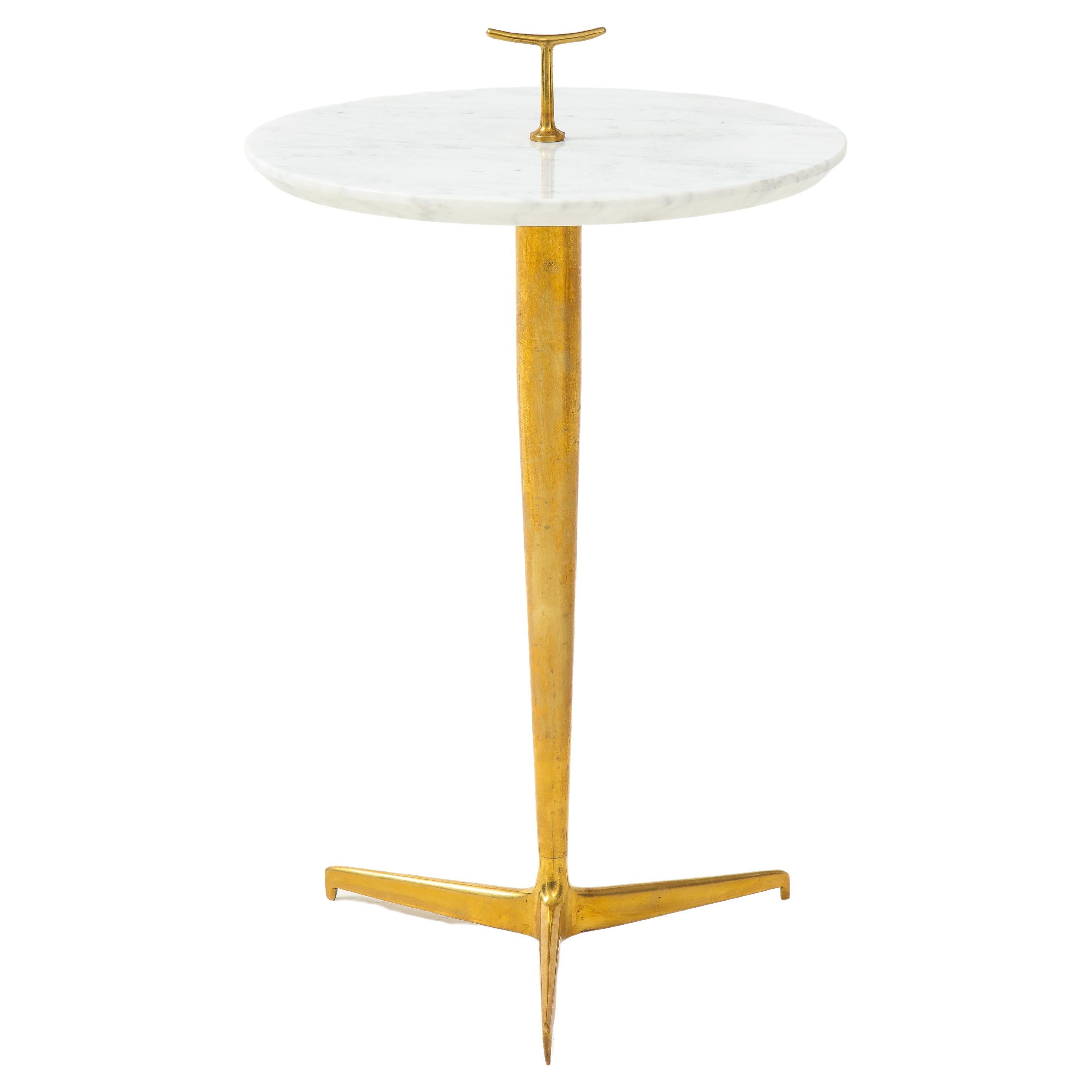 Contemporary pair of side or drinks tables each with thick Carrara marble with small brass handle detail on patinated brass tripod base, Italy, 2022. This chic modern side table is beautifully constructed with thick reverse rounded Carrara marble
