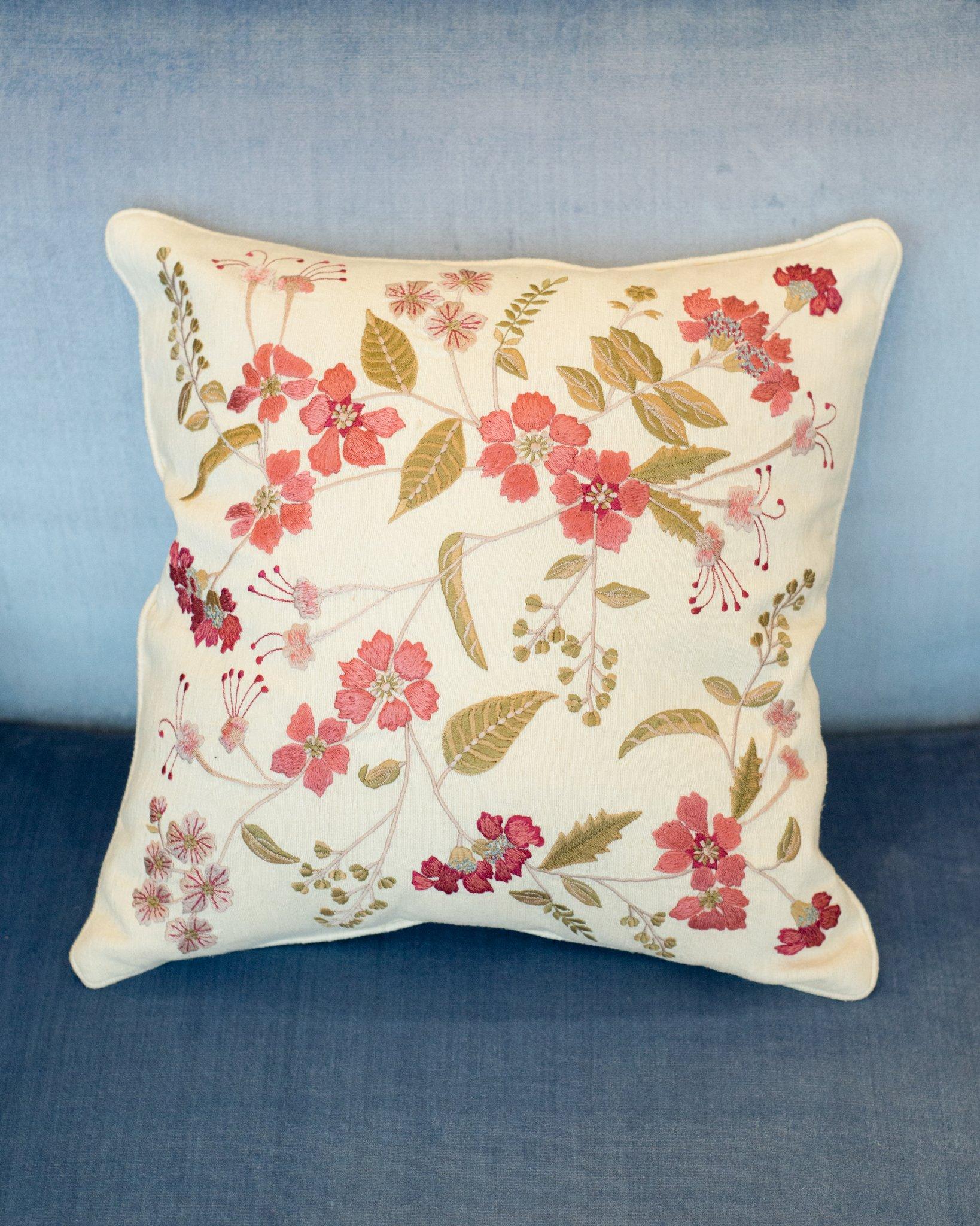 A pair of cotton cushions from Anke Dreschel featuring ornate floral embroidery, square shape and concealed rear zip fastening. Filled with 100% Canadian feather and down.