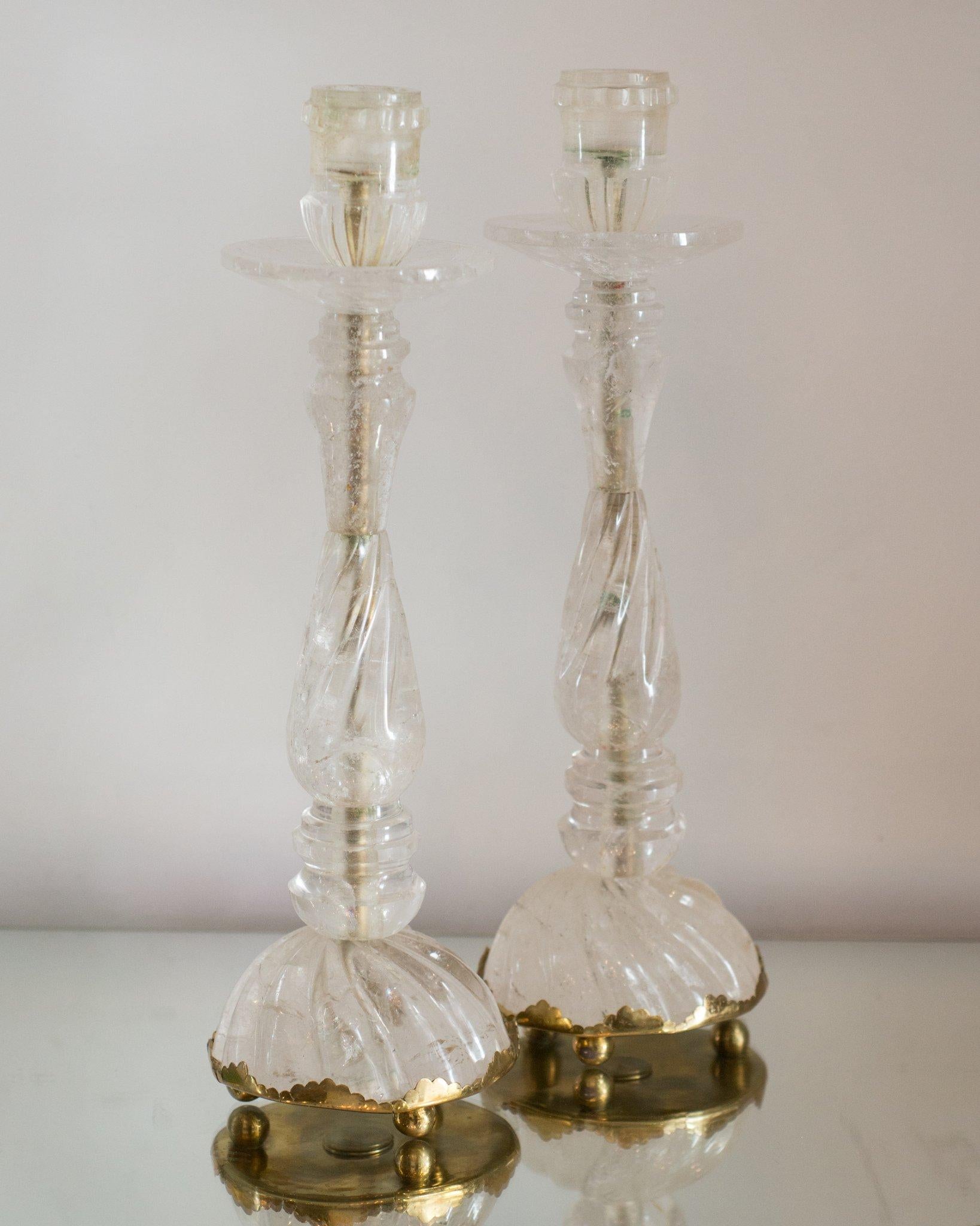 This pair of rock crystal and bronze candlesticks was sourced in Paris. Rock crystal has long been used in decoration and many ornate pieces are exhibited in museums around the world. These elegant candlesticks would suit a traditional or a
