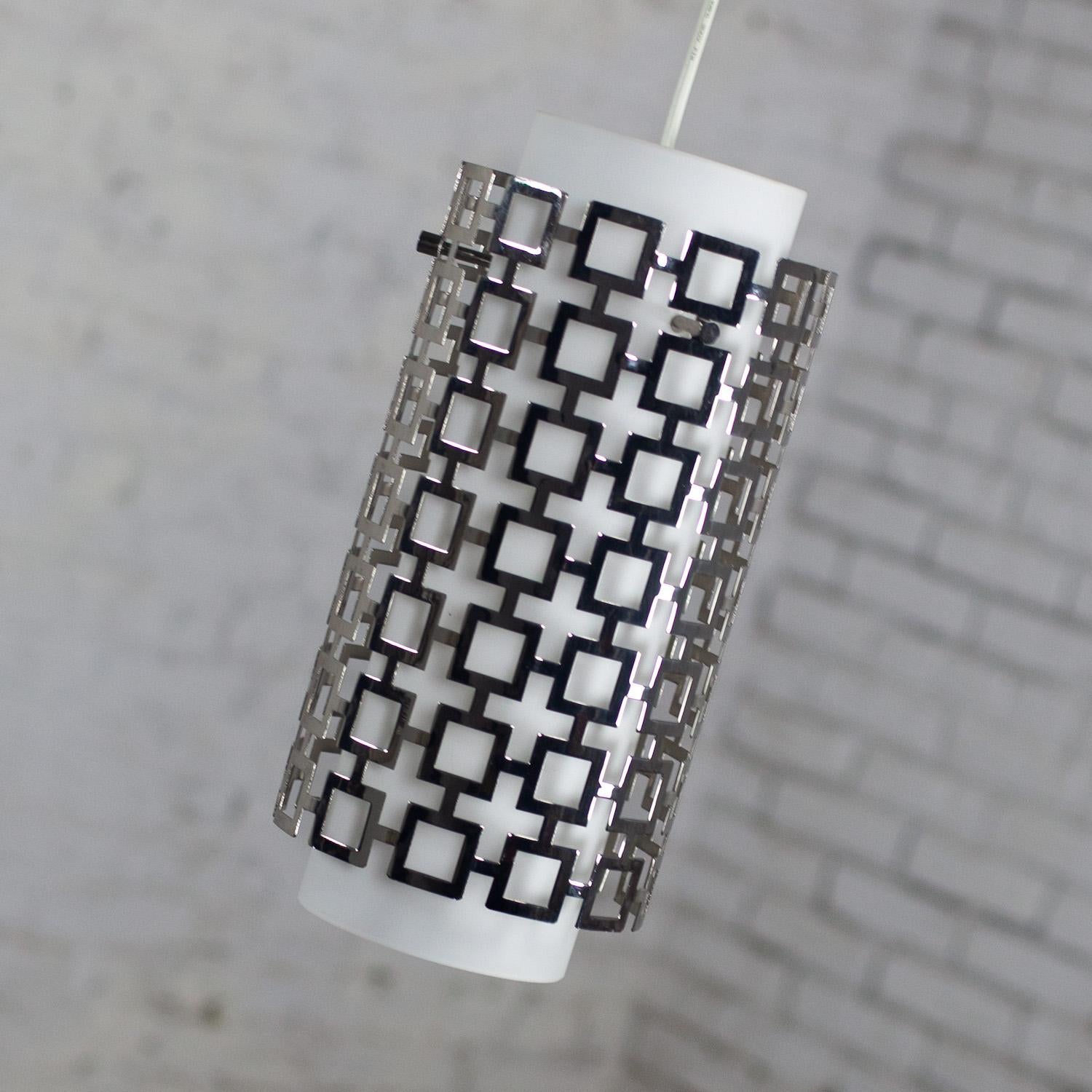 Stunning Late 20th to Early 21st Century Contemporary Transitional style Parker Pendant Light by Jonathan Adler for Robert Abbey Lighting Inc. composed of a frosted milk glass globe, polished nickel outer shade & canopy, & white hanging wire. We