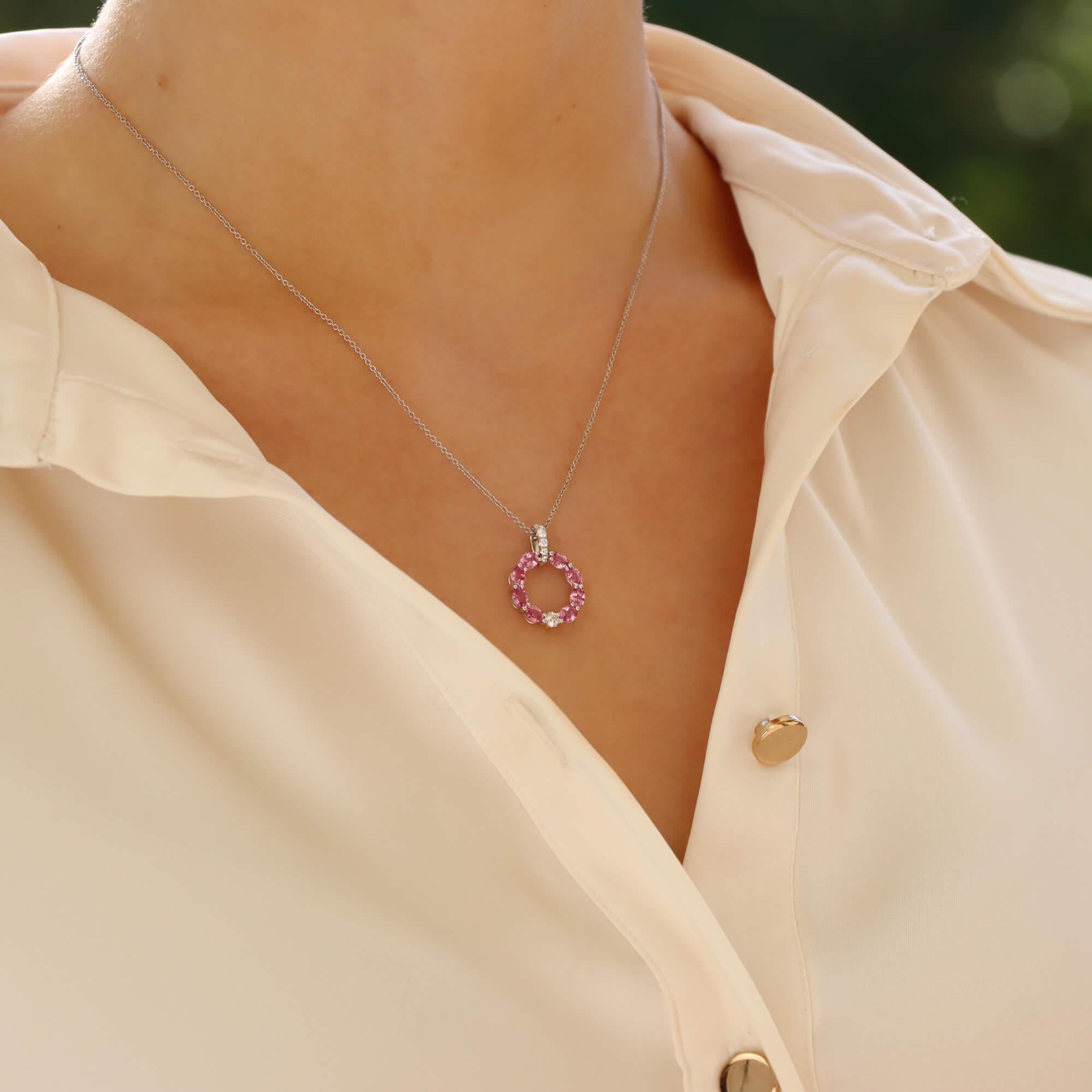 A stylish pastel pink and diamond pendant necklace set in 18k white gold.

The pendant is composed in a white gold hoop and is set throughout with oval cut pastel pink sapphires; all of which are perfectly matched in colour and lustre. The hoop