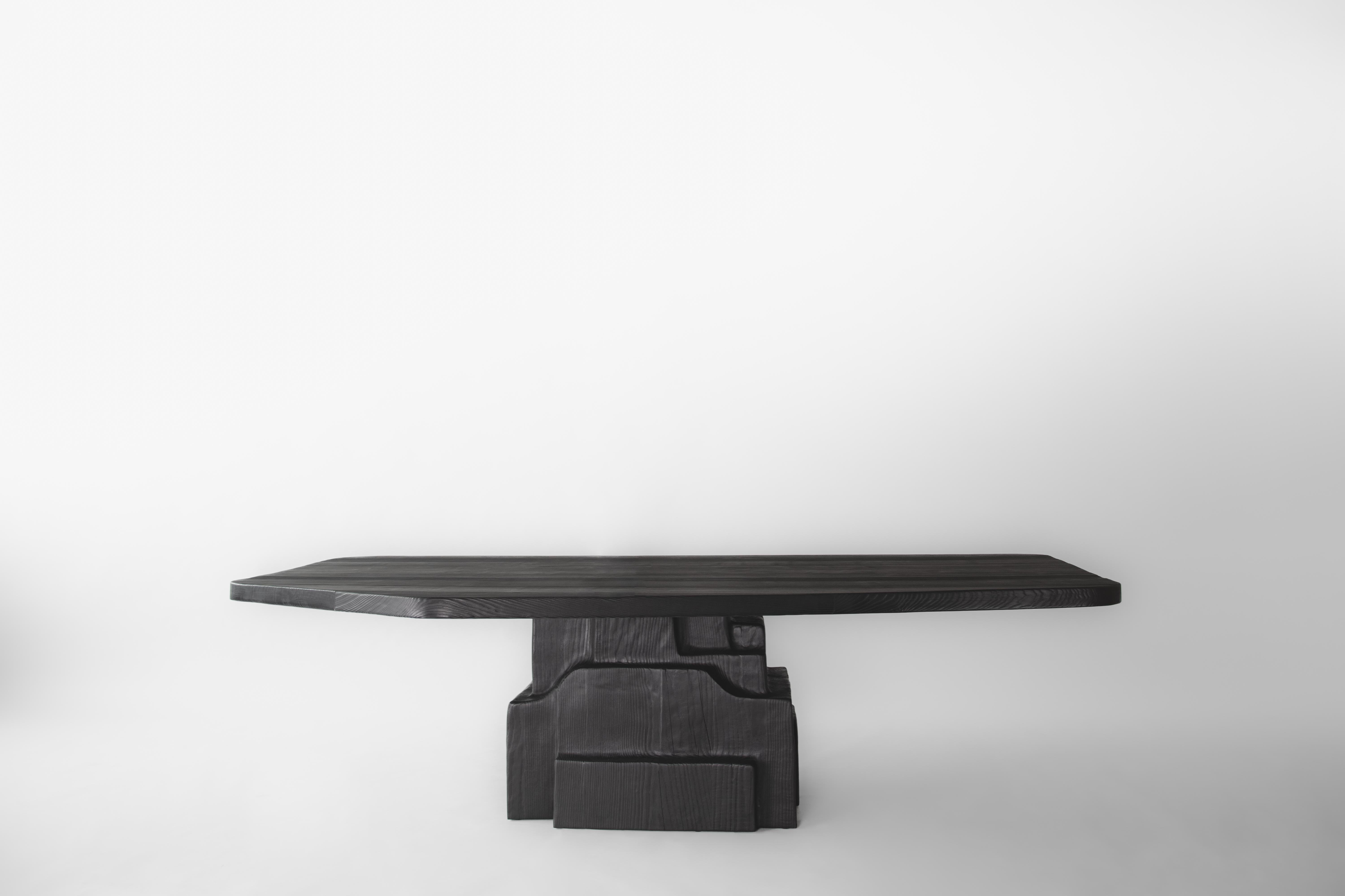 PATHOS Dining Table by German contemporary design studio Eichkorn. 
Material: Burnt Ash Wood
Standard size: H.75 x 280 x 180 cm - Customizations are possible

Made from burnt ash wood, our „PATHOS“ dining table impresses with its solid appearance.