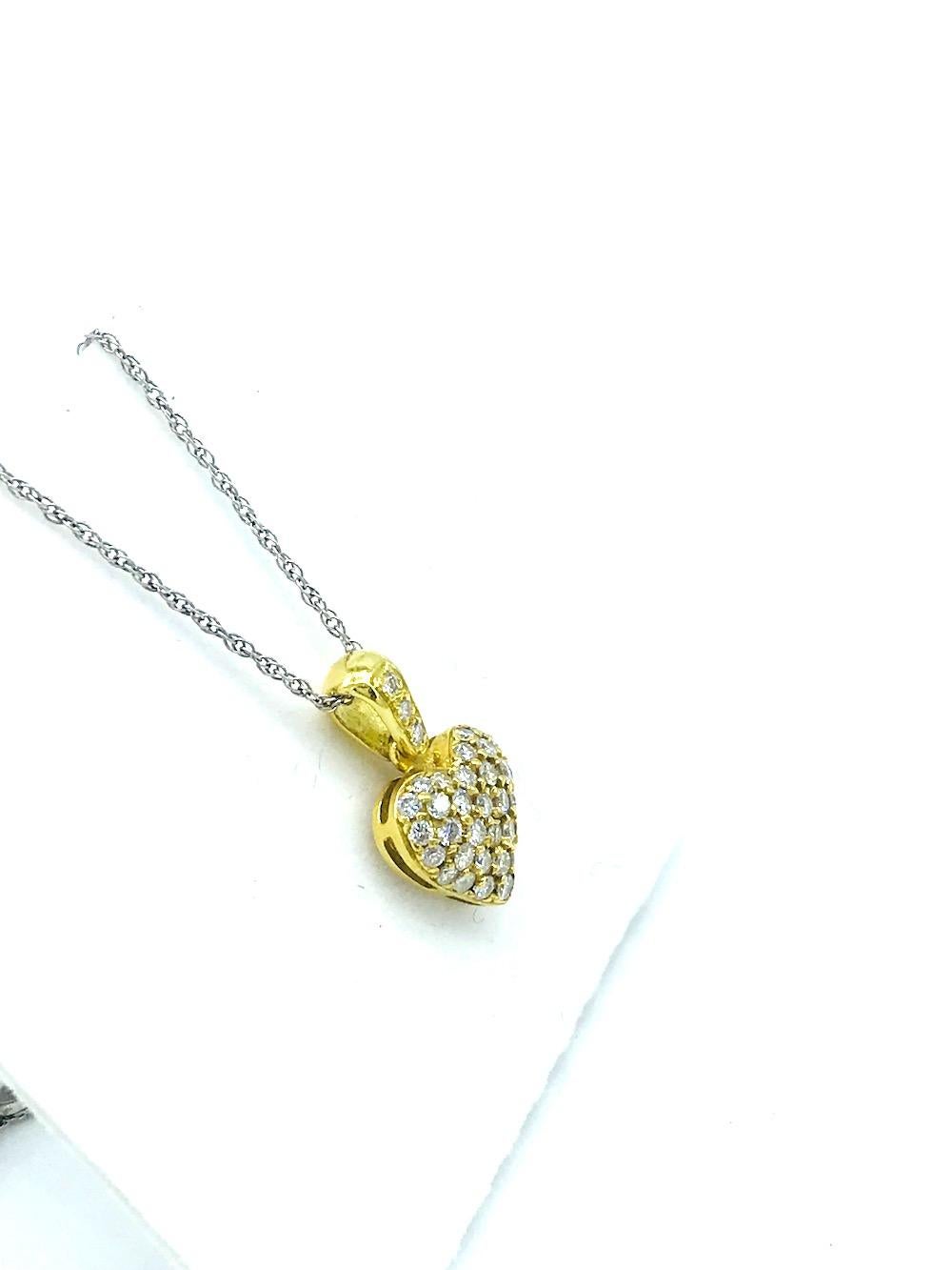 Pave Diamond Heart, 18Kt Pendant 
3/4 inch length bubble, convex shaped heart diamond pendant consisting of 37 round pave-set diamonds. Diamonds are 1.8 mm or .025 points each. Total diamond weight is .93 carat. Quality is VS2 and F color. (One