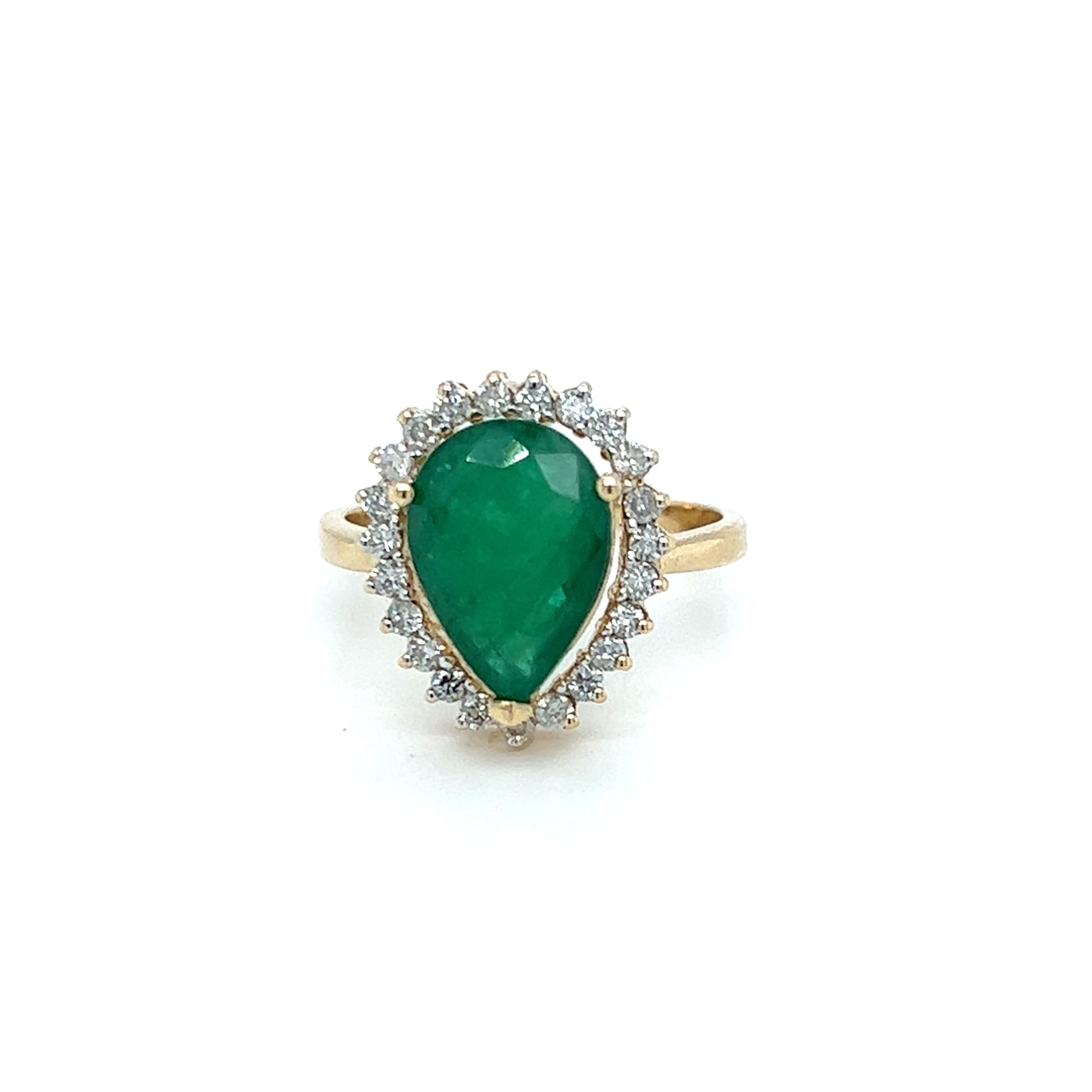 One 14 karat yellow gold ring set with one 13x8.5mm pear-shaped natural emerald, surrounded by a halo of twenty-three (23) round brilliant cut diamonds, approximately 0.33-carat
 total weight with matching H/I color and SI1 clarity. The ring is a