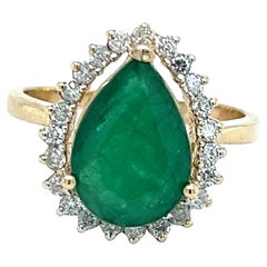 Contemporary Pear Shaped Emerald Diamond Halo Ring in 14K Yellow Gold