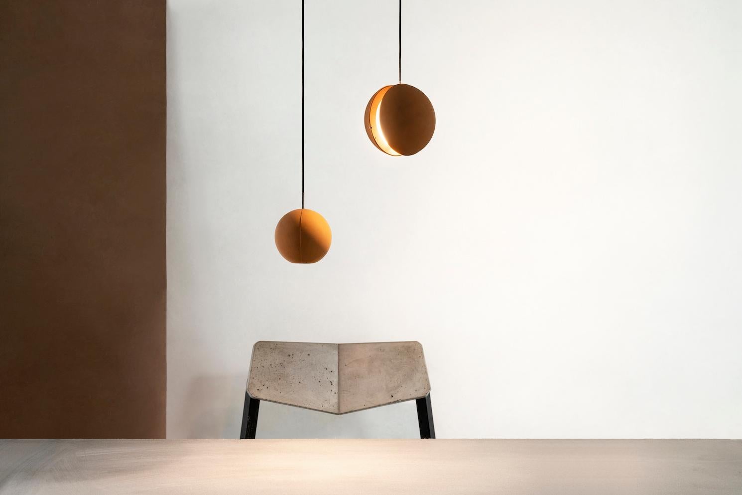 Pendant lamp 'E-mars' by Nongzao x Bentu Design.
Material: Terracotta 
Color: Earthy orange 

Measures: 10.2 cm high, 9.8 cm diameter
Wire: 3 meters (black)
Lamp type: AC 100-240V 50-60Hz 9W - Comptable with US electric