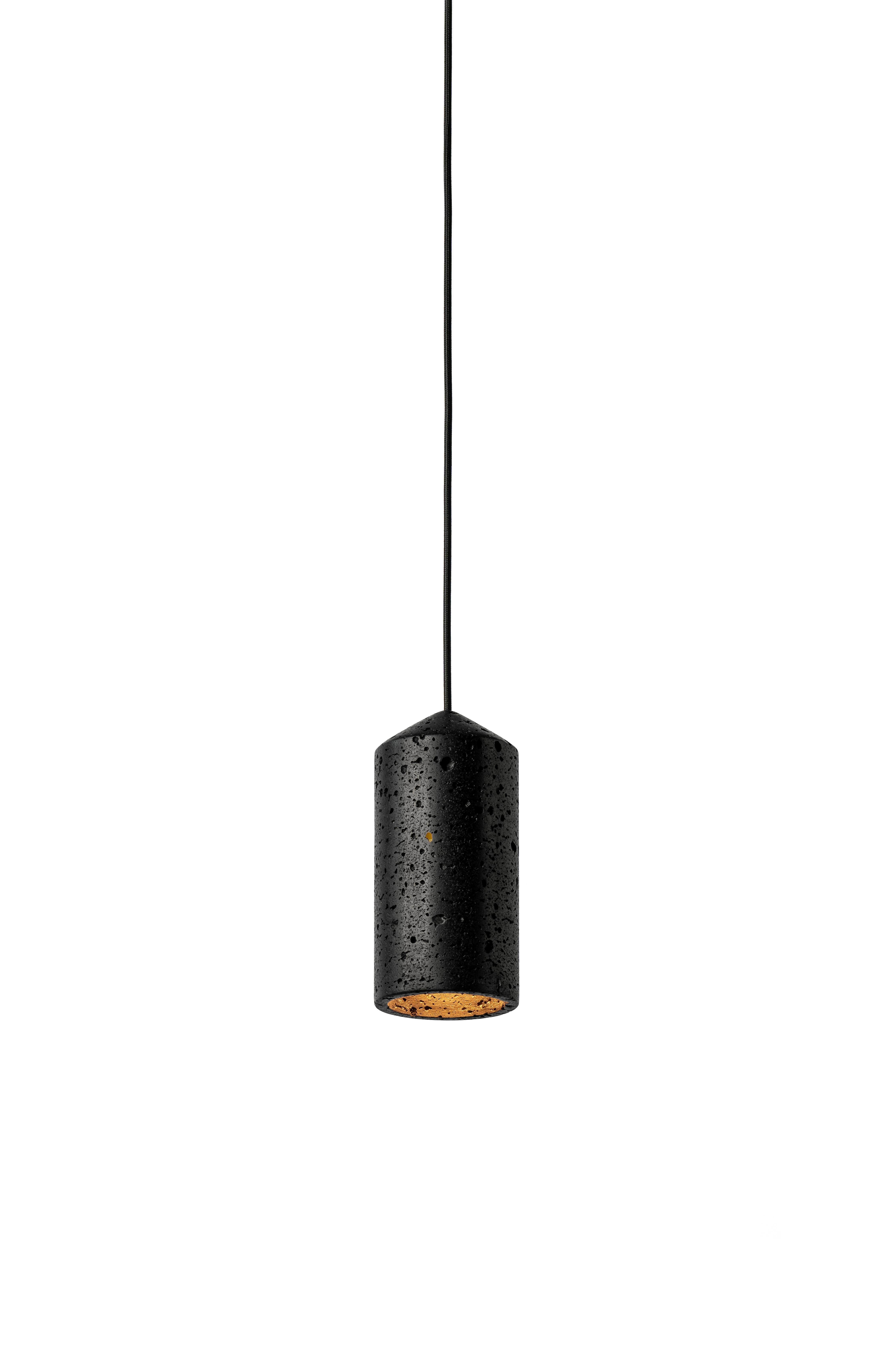 Pendant lamp 'IN' by Buzao x Bentu design.
Black lava stone

Measures: 23 cm high, 11 cm diameter
Wire: 2 meters black (adjustable) 
Lamp type: E27 LED 3W 100-240V 80Ra 200LM 2700K - Comptable with US electric system.
Ceiling rose: 6.5cm diameter