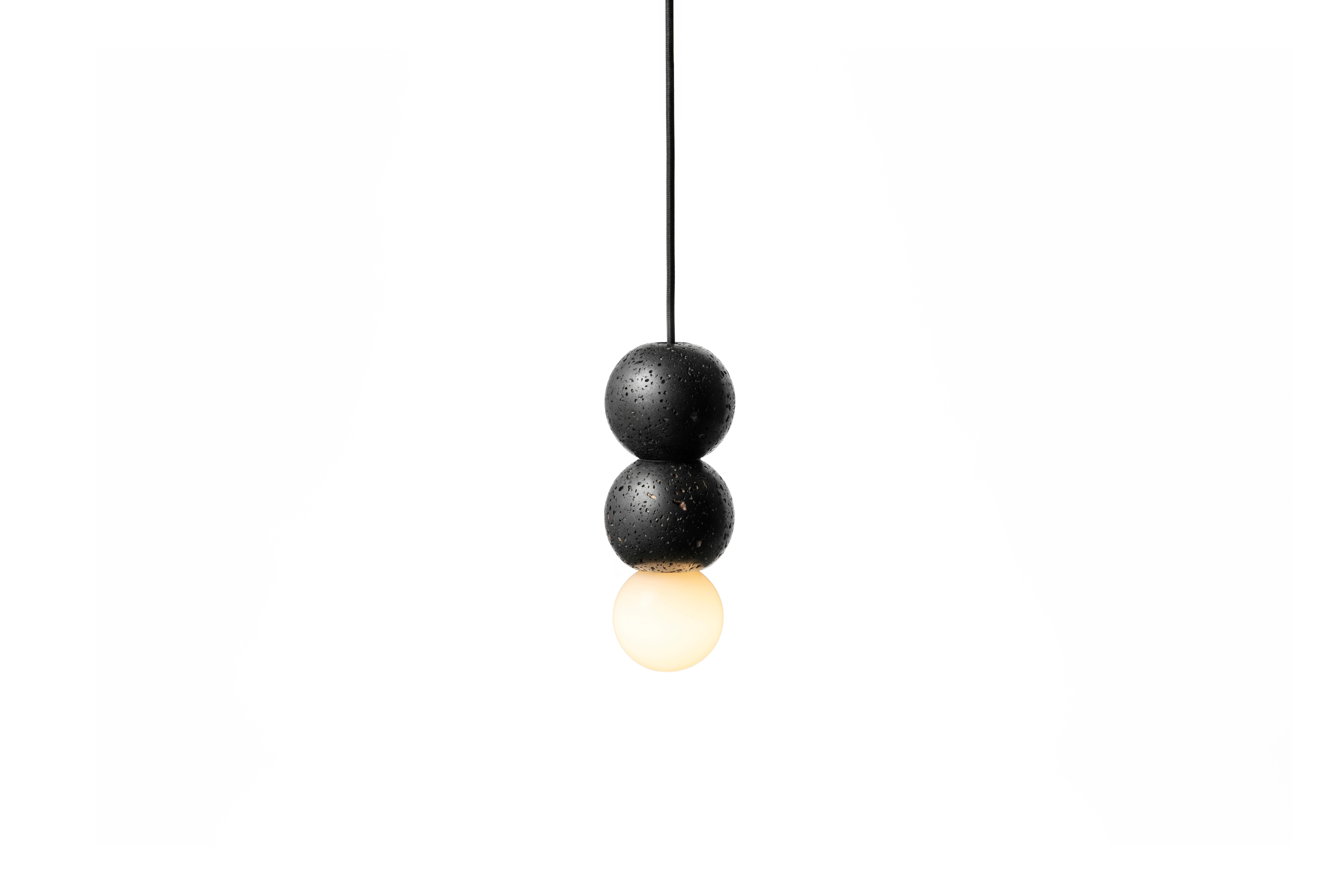 Pendant lamp 'OOPS' by Buzao x Bentu design.
Black lava stone

Size: 24 cm high, 9 cm diameter
Wire: 2 meters black (adjustable)
Lamp type: E27 LED 3W 100-240V 80Ra 200LM 2700K - Comptable with US electric system.
Ceiling rose: 6.5cm diameter