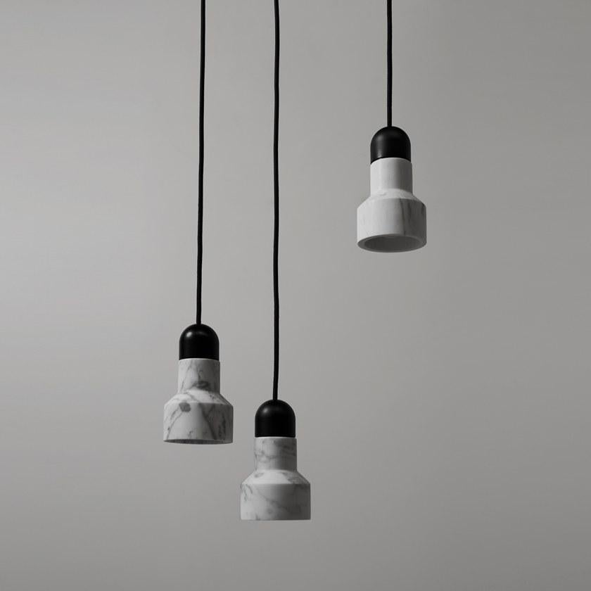 Pendant lamp 'QIE' by Buzao x Bentu Design. 
After concrete version, let's meet the black lava stone and white marble version version!

(Sold individually)

16 cm High; 9.6 cm Length
Wire: 2meters black (adjustable)

Brass (gold) or aluminum (black)