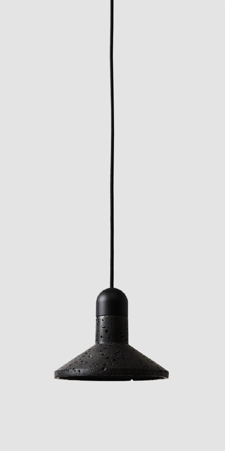 Pendant lamp 'SHANG' by Buzao x Bentu Design. 
After concrete version, let's meet the black lava stone version!

(Sold individually)

Measures: 16 cm High; 20 cm Length
Wire: 2 Meters Black (adjustable)

Brass (gold) or aluminum (black)