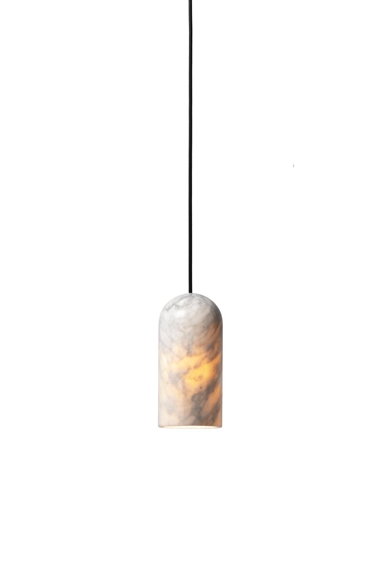 Pendant lamp 'U2' by Buzao x Bentu design.
White marble

Measures: 23 cm high, 11 cm diameter
Wire: 2 meters black (adjustable)
Lamp type: E27 LED 3W 100-240V 80Ra 200LM 2700K - Comptable with US electric system.
Ceiling rose 6.5cm diameter