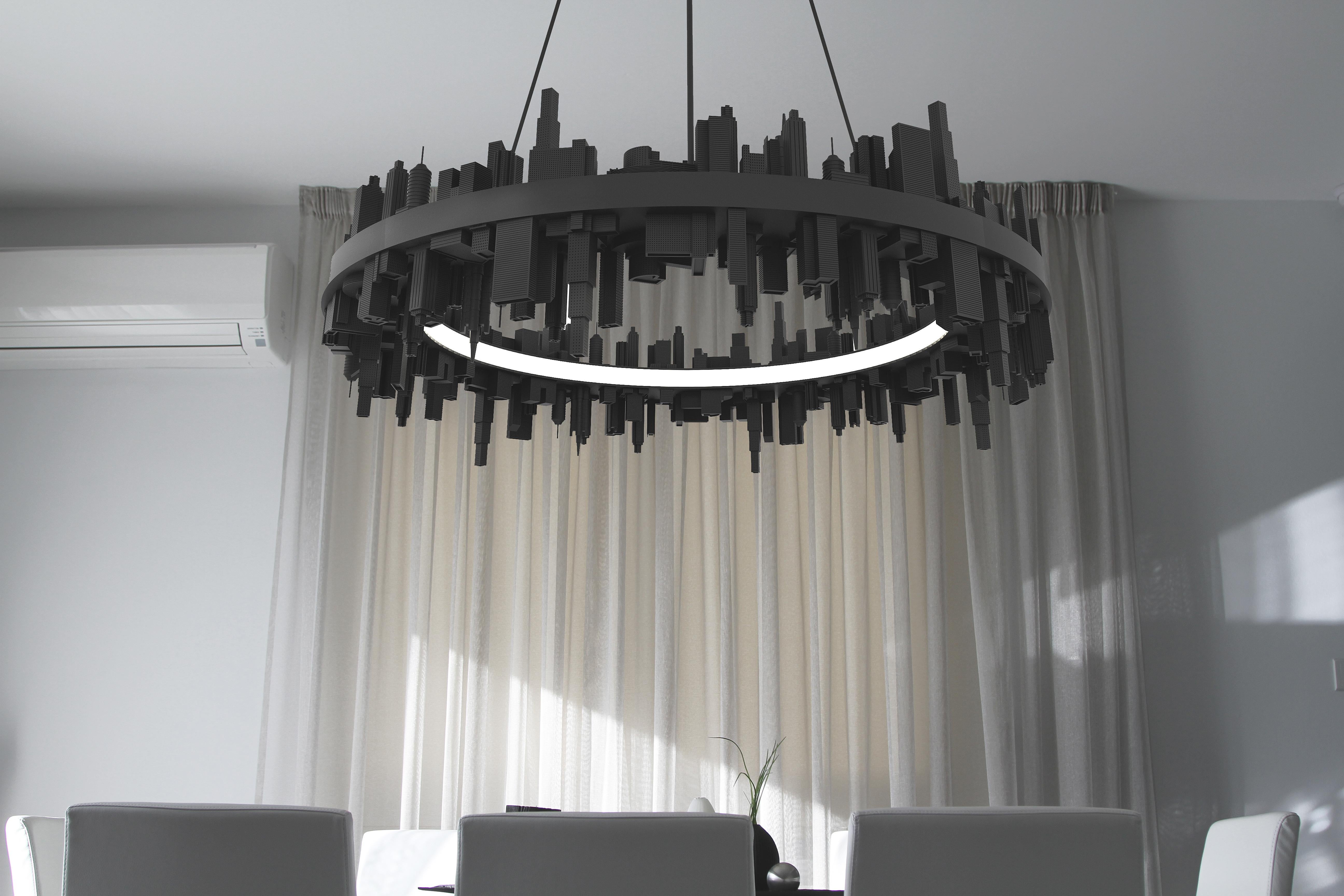 Lampada a sospensione City

La caratteristica più sorprendente di questa lampada a sospensione è la miniatura di uno skyline immaginario incapsulato nella sua forma. Questo skyline, meticolosamente realizzato da Mousarris, gioca con ombre