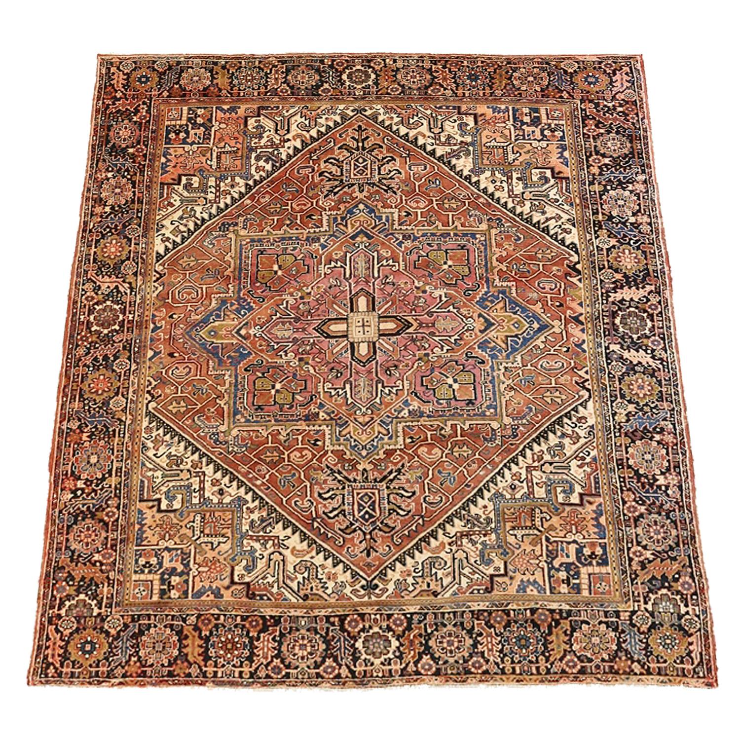 Contemporary Persian rug handwoven from the finest sheep’s wool and colored with all-natural vegetable dyes that are safe for humans and pets. It’s a traditional Heriz design featuring a lovely ivory field covered with black, blue, red and pink