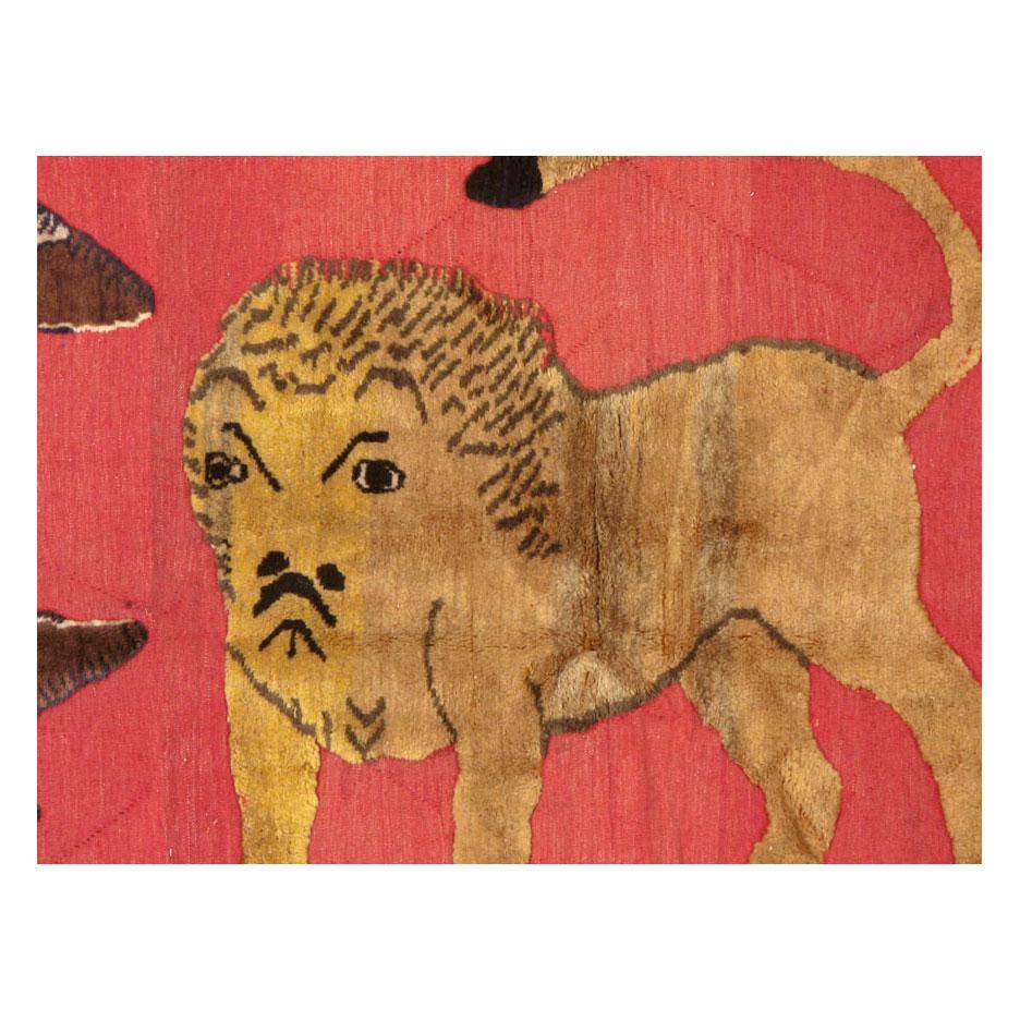 A modern Persian pictorial accent rug handmade during the mid-20th century with a 'souf' weaving technique in which the background is flat-woven (hand-woven) while the design is a raised pile (hand-knotted). The lion is inspired by classic Persian