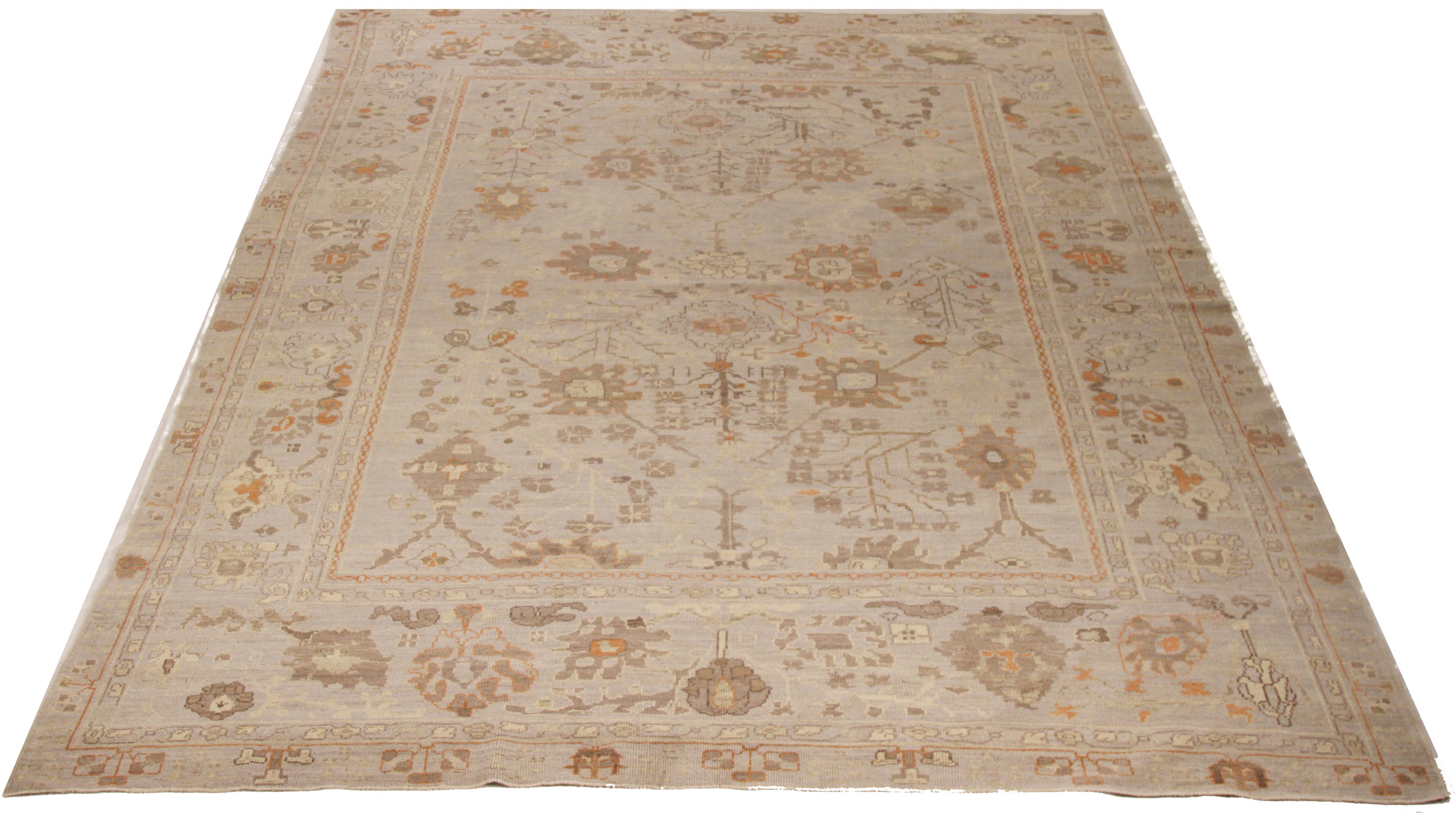 Persian rug handwoven from the finest sheep’s wool and colored with all-natural vegetable dyes that are safe for humans and pets. It’s a traditional Oushak design featuring a gray open field filled with intricate floral details in beige and rust