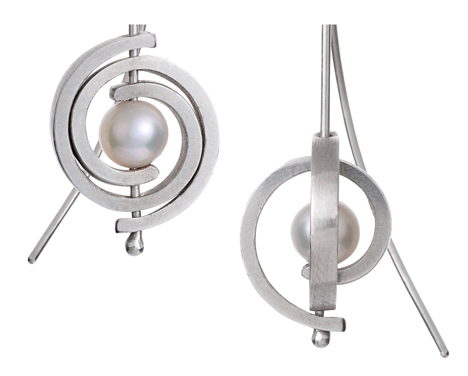 From the Orbit collections - the Petite Spiral Dangle Earrings are a contemporary classic earring.  They are like little luminous planets with rings. Dangling 1.5