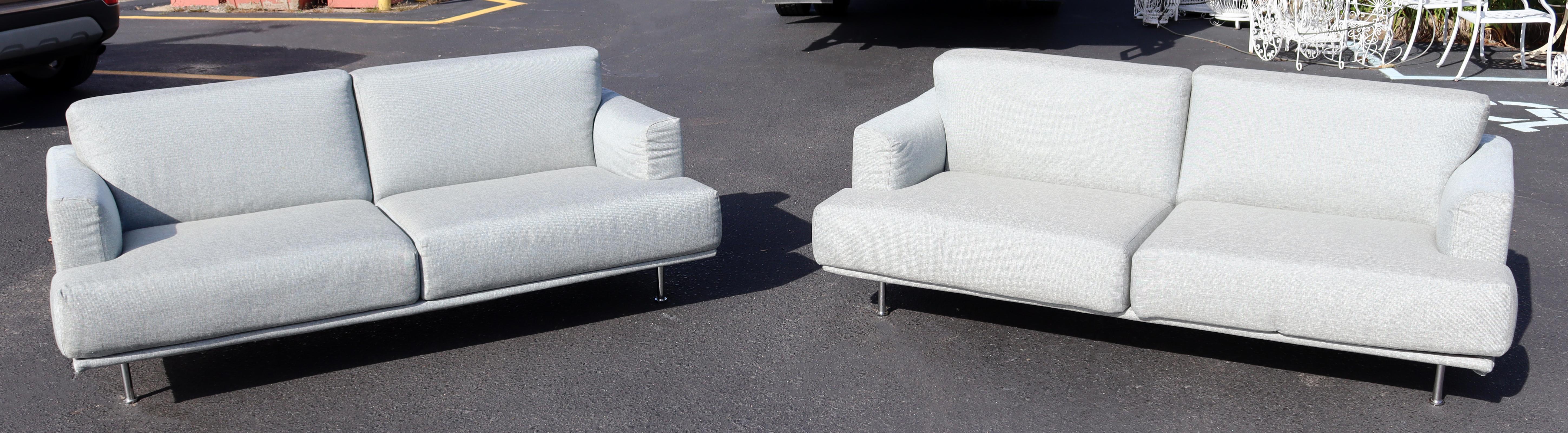 For your consideration is a perfect pair of Nest sofas, with a dove gray upholstery on tubular chrome bases, made in the Italy, by Piero Lissoni for Cassina, circa the 1990s. In excellent condition. The dimensions of each are 77