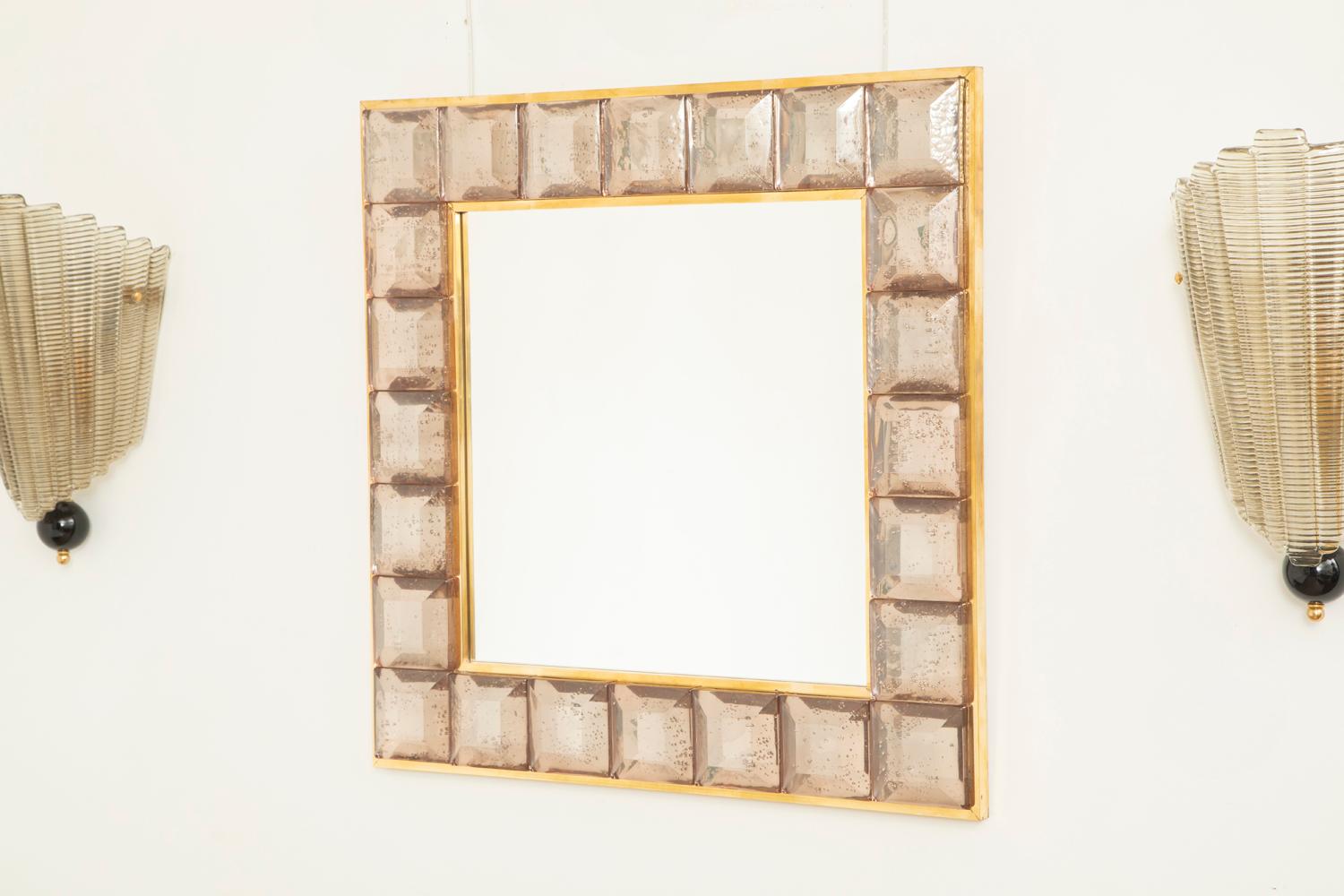 Contemporary pink square diamond cut Murano glass mirror.
Pink glass block with naturally occurring air inclusions throughout 
 Highly polished faceted pattern
 Brass gallery
 Luxury handcrafted by a team of artisans in Venice, Italy.
 Weight Lbs