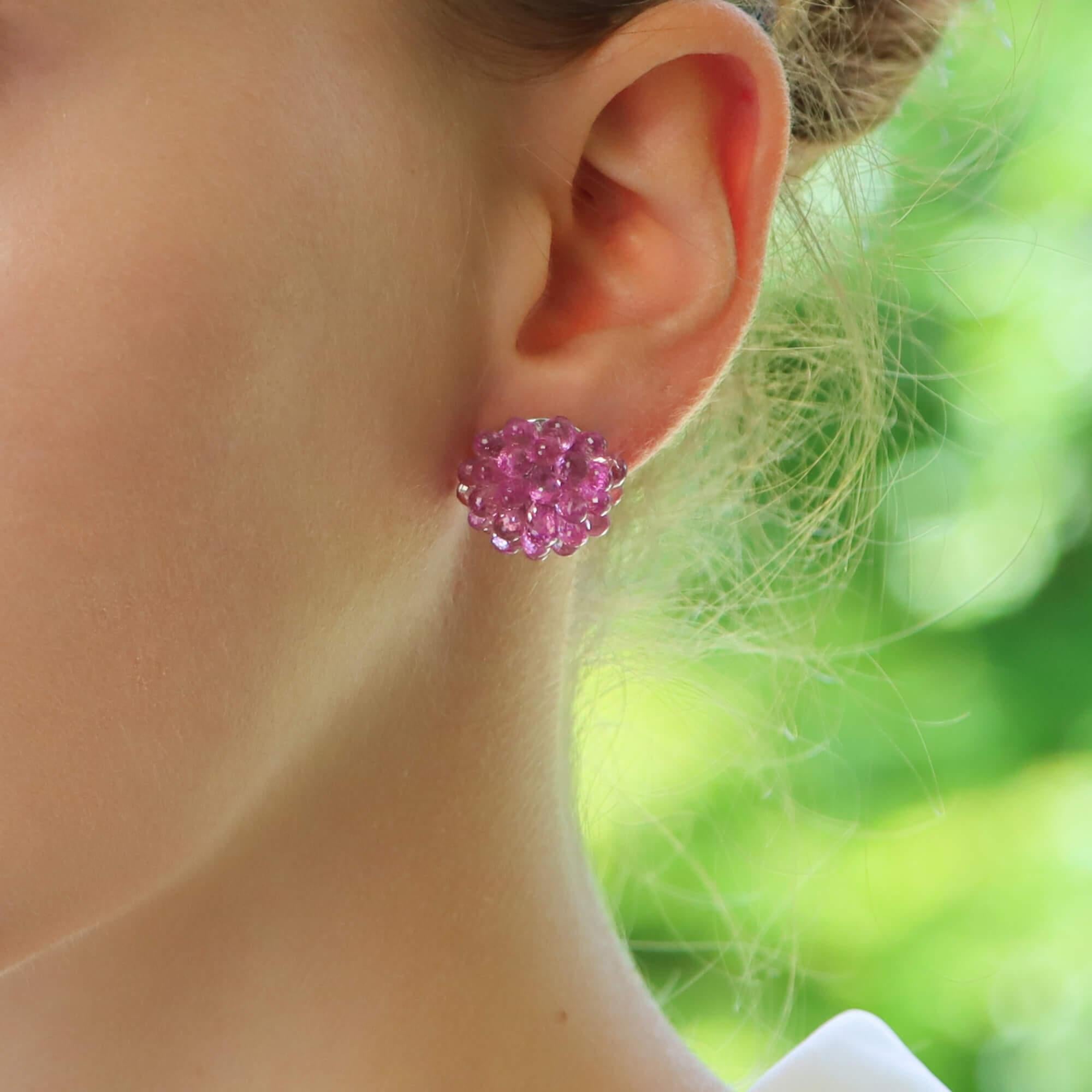 A beautiful pair of pink sapphire and diamond drop earrings set in 18k white gold.

Each earring is firstly composed of a small oval cut pink sapphire which is four claw set and secured to reverse with a post and butterfly fitting. Hanging from this