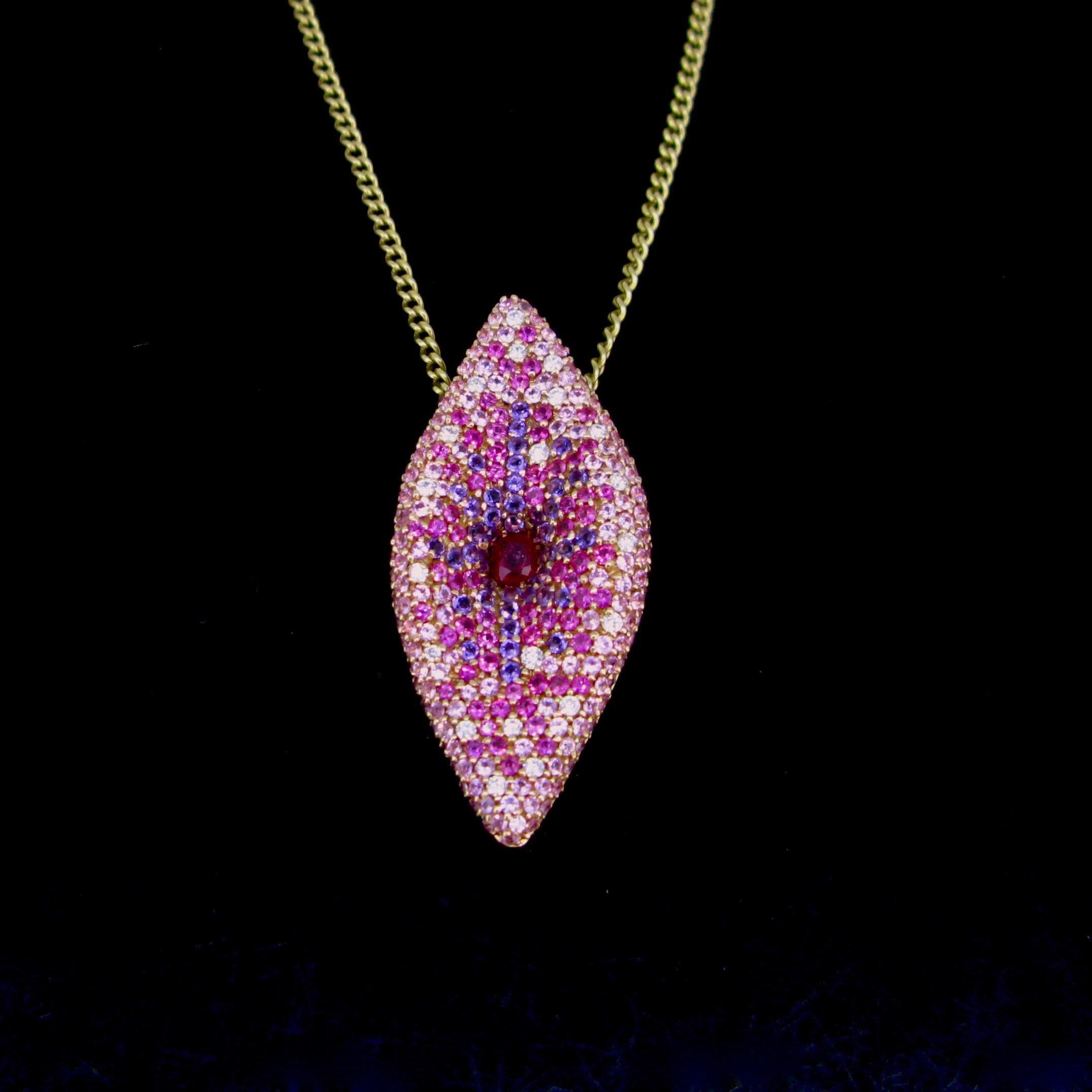 Weight:	10.80gr

Metal:		18kt rose Gold

Stones:	1 Ruby
•	Cut:	oval
•	Carat Weight:	0.40ct approx.

Others: 	220 Pink Sapphires
	30 Amethysts
	20 Diamonds

Condition:	Very Good

Hallmarks:	UK

Comments: 	This beautiful contemporary pendant designed