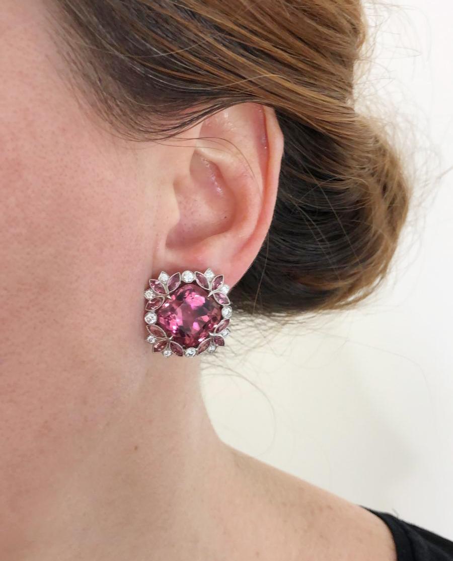 Contemporary Pink Tourmaline Diamond Earrings in Platinum and 18k White Gold.

Classic brilliant-cut pink tourmalines mounted in a halo of matching pink marquise-shapes and round white diamonds, set shallow to the ear with lever backs. The depth of