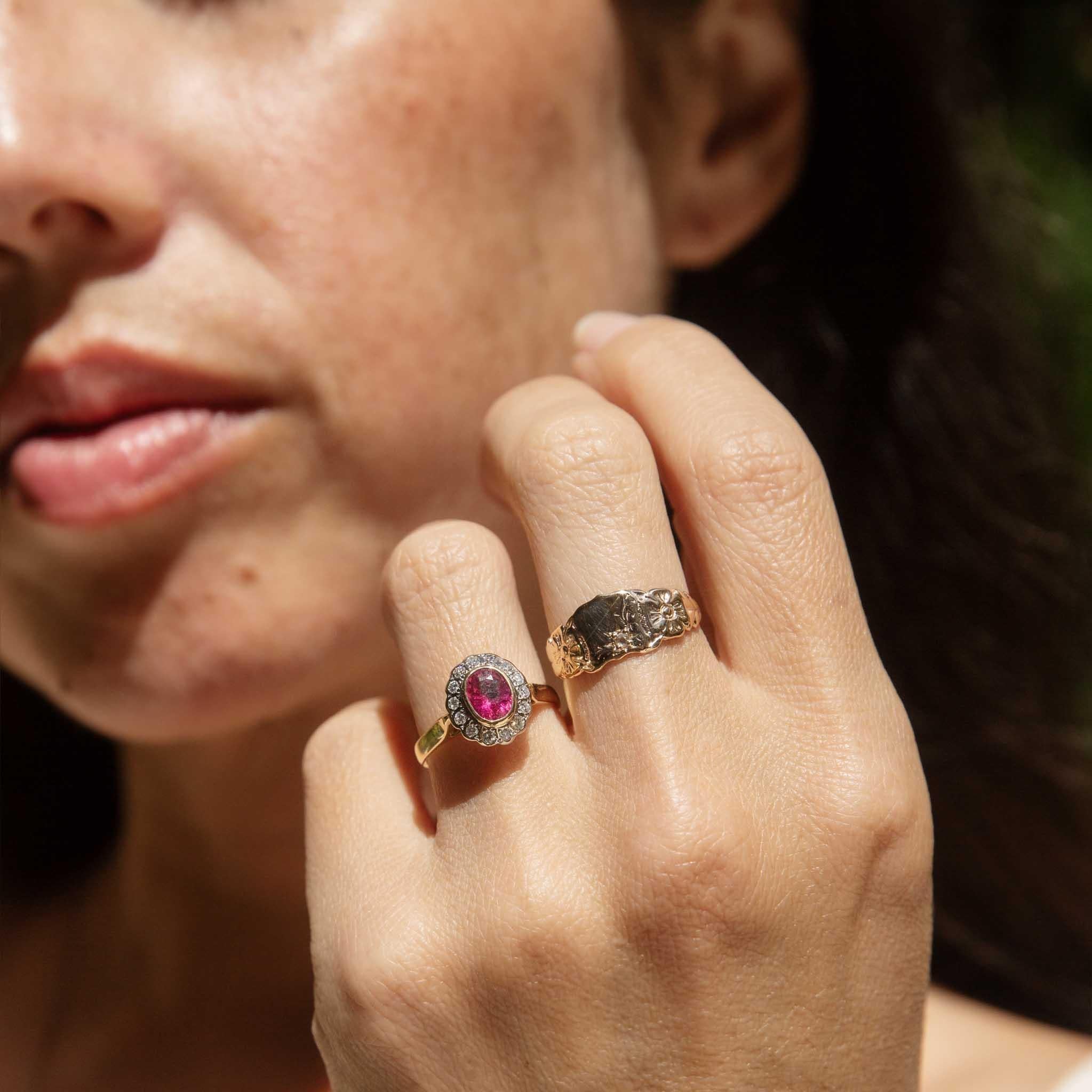 Radiating feminine charm, our Shea Pink Tourmaline Diamond Halo Ring is a sweet treasure. Her vibrant oval pink tourmaline, reminiscent of blossoms in bloom, sits at her centre, encircled by a dazzling halo of brilliant-cut diamonds. The high-polish