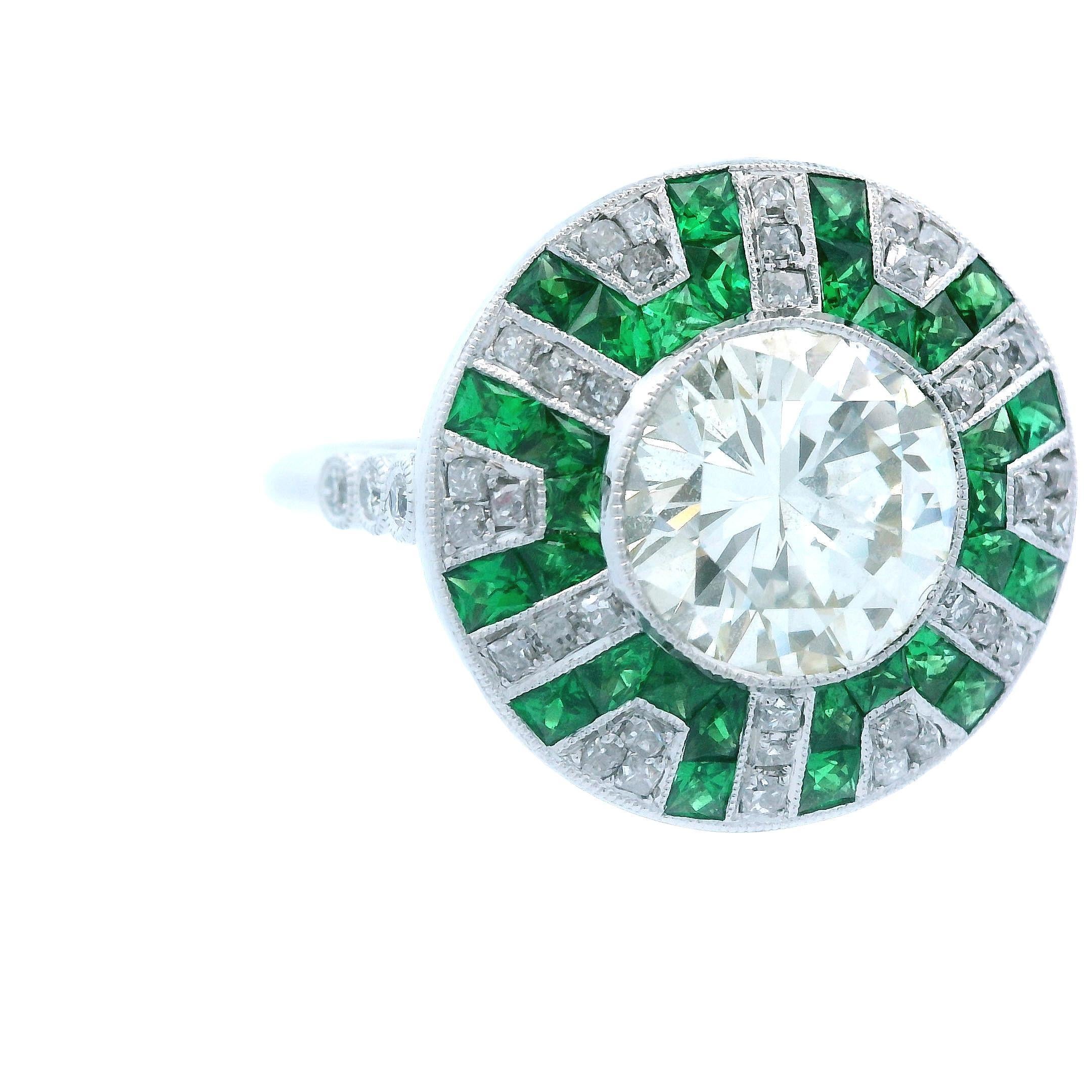 This gorgeous contemporary ring is made in platinum and features both tsavorite garnet and diamond. This ring is so special because of the vivid green tsavorite, which is often mistaken for emerald, as well as it being made in platinum, instead of