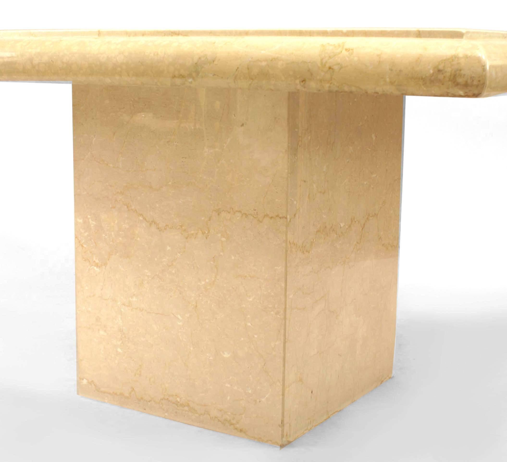 Contemporary polished travertine marble dining table with a square top resting on a square pedestal base.