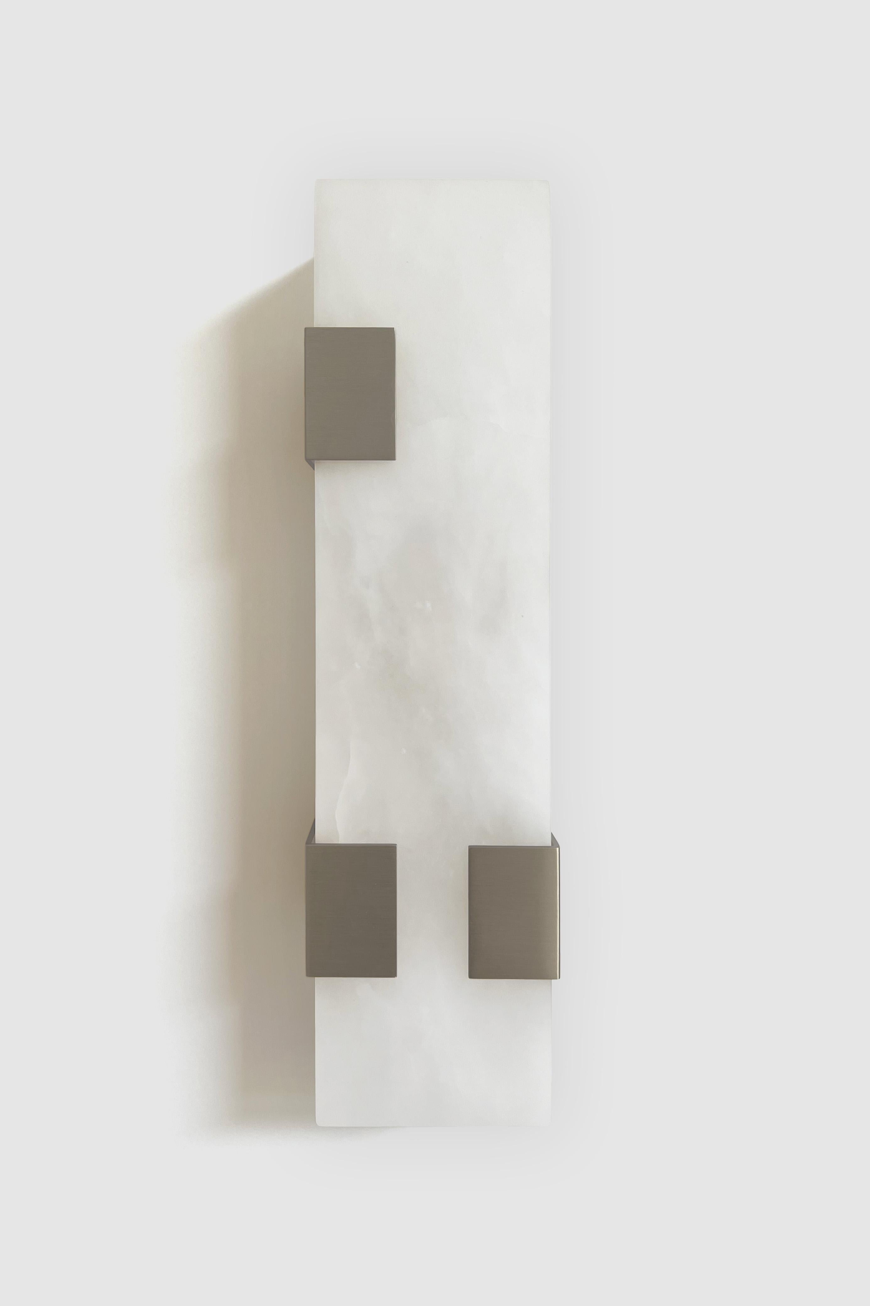 Orphan Work 003-3C Sconce
Shown in brushed nickel and alabaster
Available in brushed brass, brushed nickel and blackened brass
Measures: 19”H x 5 1/4”W x 3 7/8”D
Wall or ceiling mount
Vertical or horizontal
Plug-in by request
1-4 adjustable clips
UL