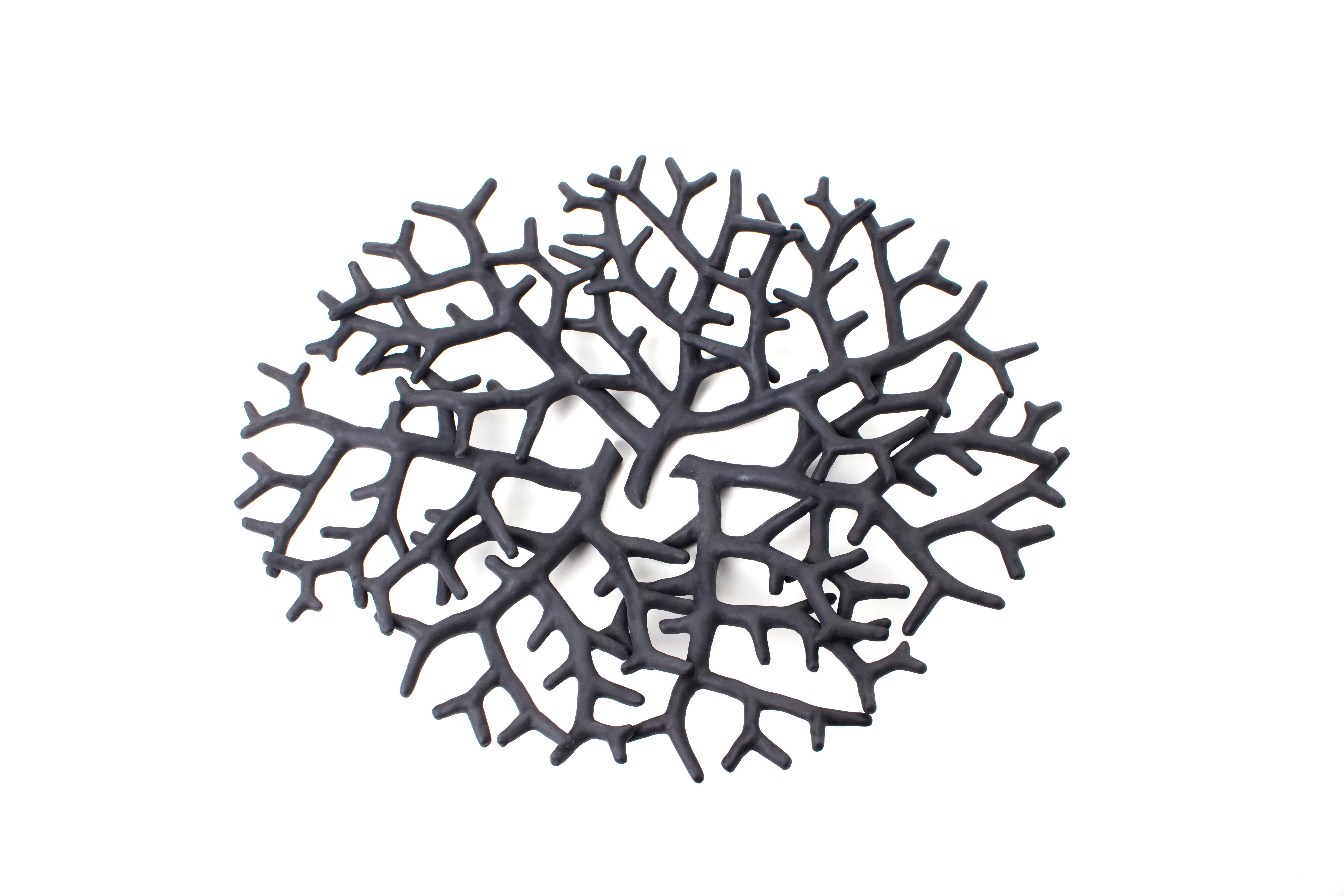 An underwater garden, populated by animals and plants from the Deep, is the main source of inspiration for this total black porcelain centerpiece. A sculpture, where shape triumphs over functionality, in a mesmerizing twist of corals. The matt black