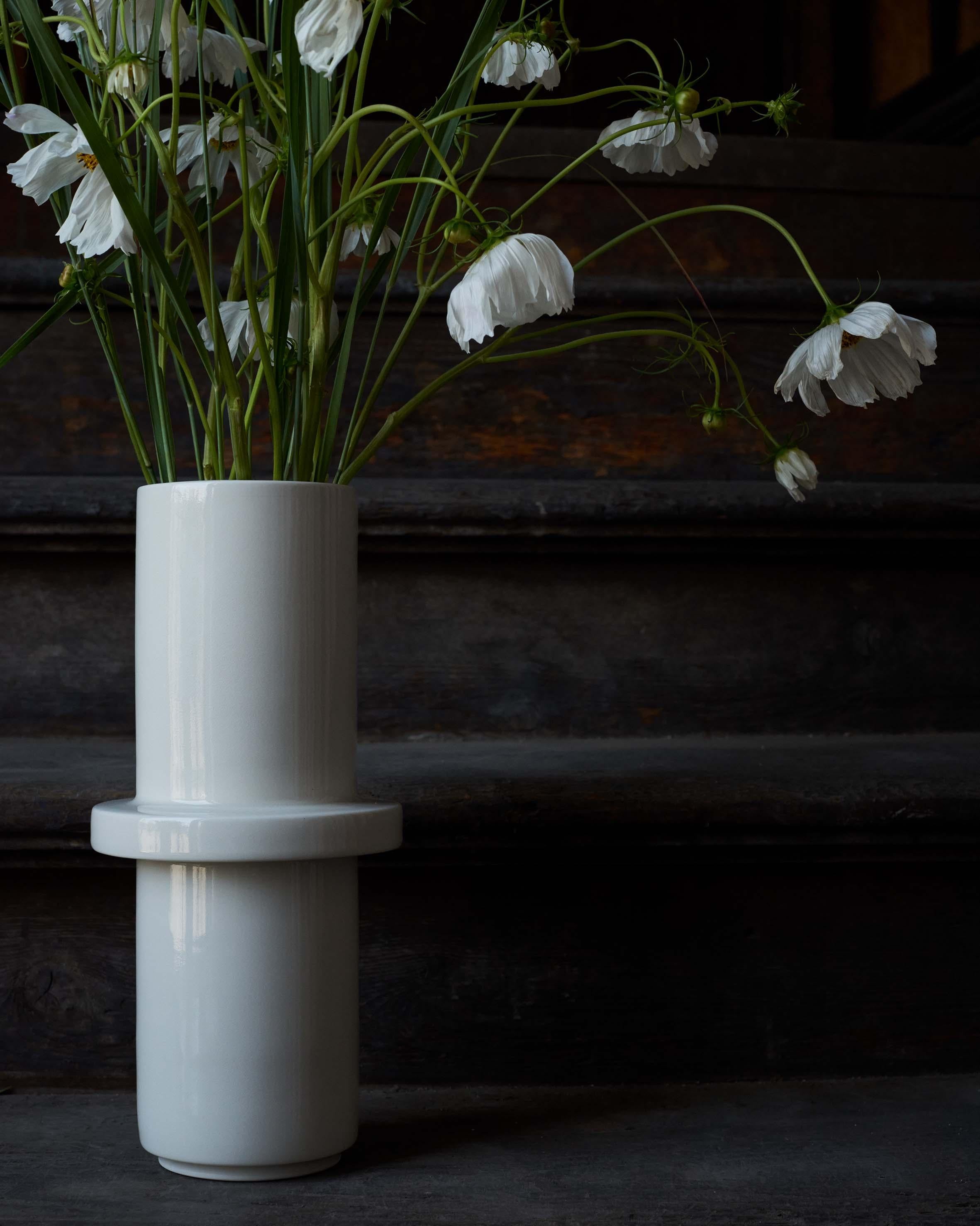 This hand-thrown porcelain vase is a contemporary and functional stand out piece. The vase is hand-thrown from white porcelain with transparent glaze. The vase has a size of diameter 15cm, height 33cm. 

The first Atlas Crafts collection is thrown