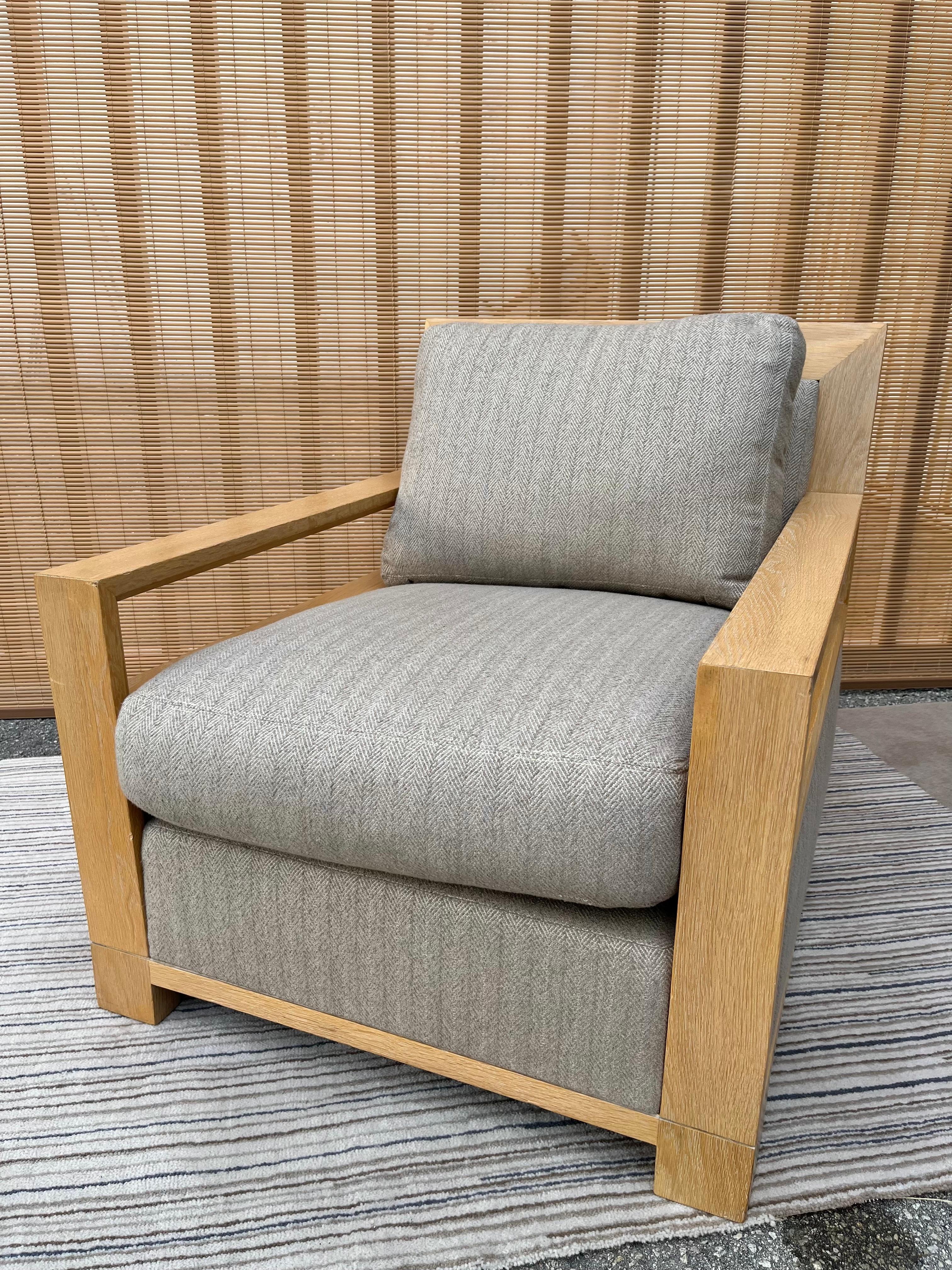 Contemporary portrait club / lounge chair by the American Designer Ted Boerner. Circa Early 21st Century. 
Features a sharp straight lines contemporary design with an exposed wood frame that surrounds the back and the arm-rests, making this