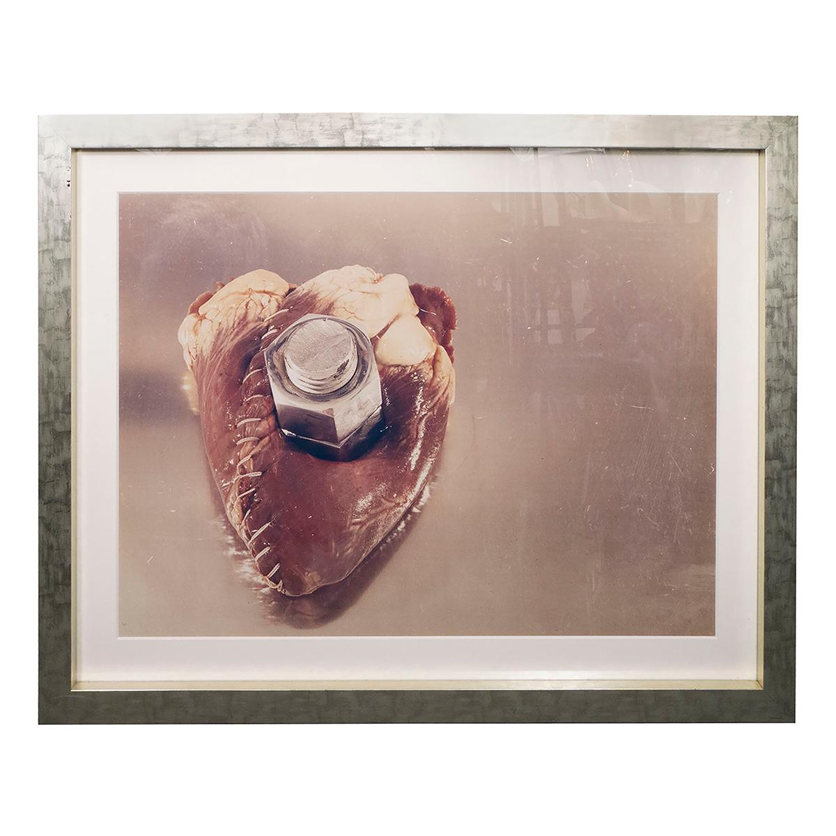 Large format Contemporary Postmodern Chromogenic Photograph depicting a human heart stitched and bolted together. Verso signed, numbered, titled, and dated: 