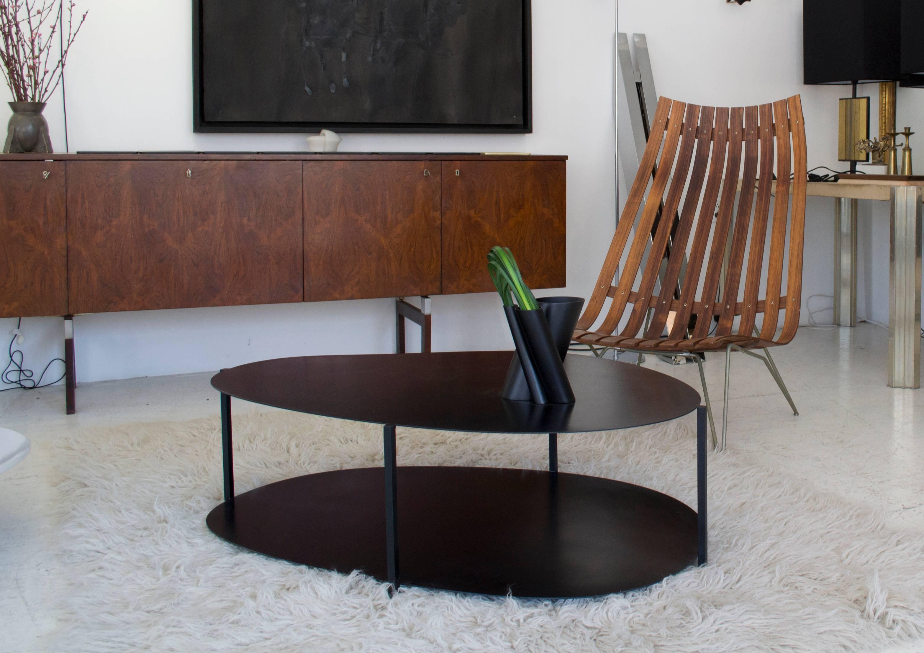 Named after the Japanese word for ‘river rock’ the Ishicoro contemporary coffee table is composed of two different organic shapes held together in contrast by square bars creating a delicate balance of the minimal structure, which is both formal and