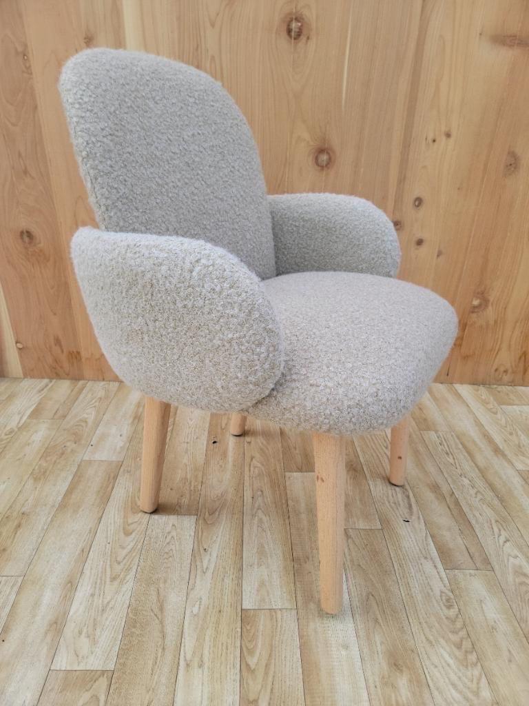 Dost wood base accent chair by Puik newly upholstery in a high end boucle.

Named for the native word meaning ‘friendship’, the Dost side chair was inspired by one of our most basic human needs: comfort. This inviting, cozy chair has been designed